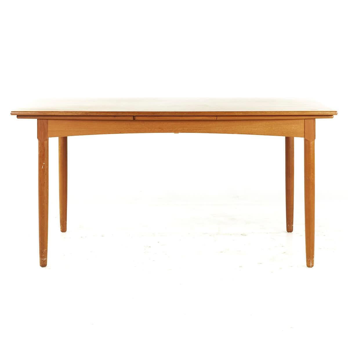 Kurt Ostervig Style Mid Century Teak Hidden Leaf Dining Table

This table measures: 60 wide x 39 deep x 29.25 high, with a chair clearance of 25 inches, each hidden leaf measures 21.75 inches, making a maximum table width of 103.5 inches when both