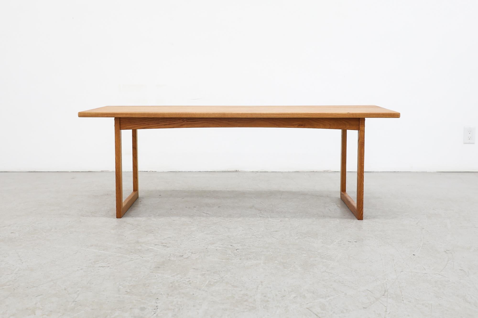 Mid-century Kurt Østervig style oak coffee table with simple box square frame and u-shaped legs. In original condition with some fading to the table top, consistent with its age and use.