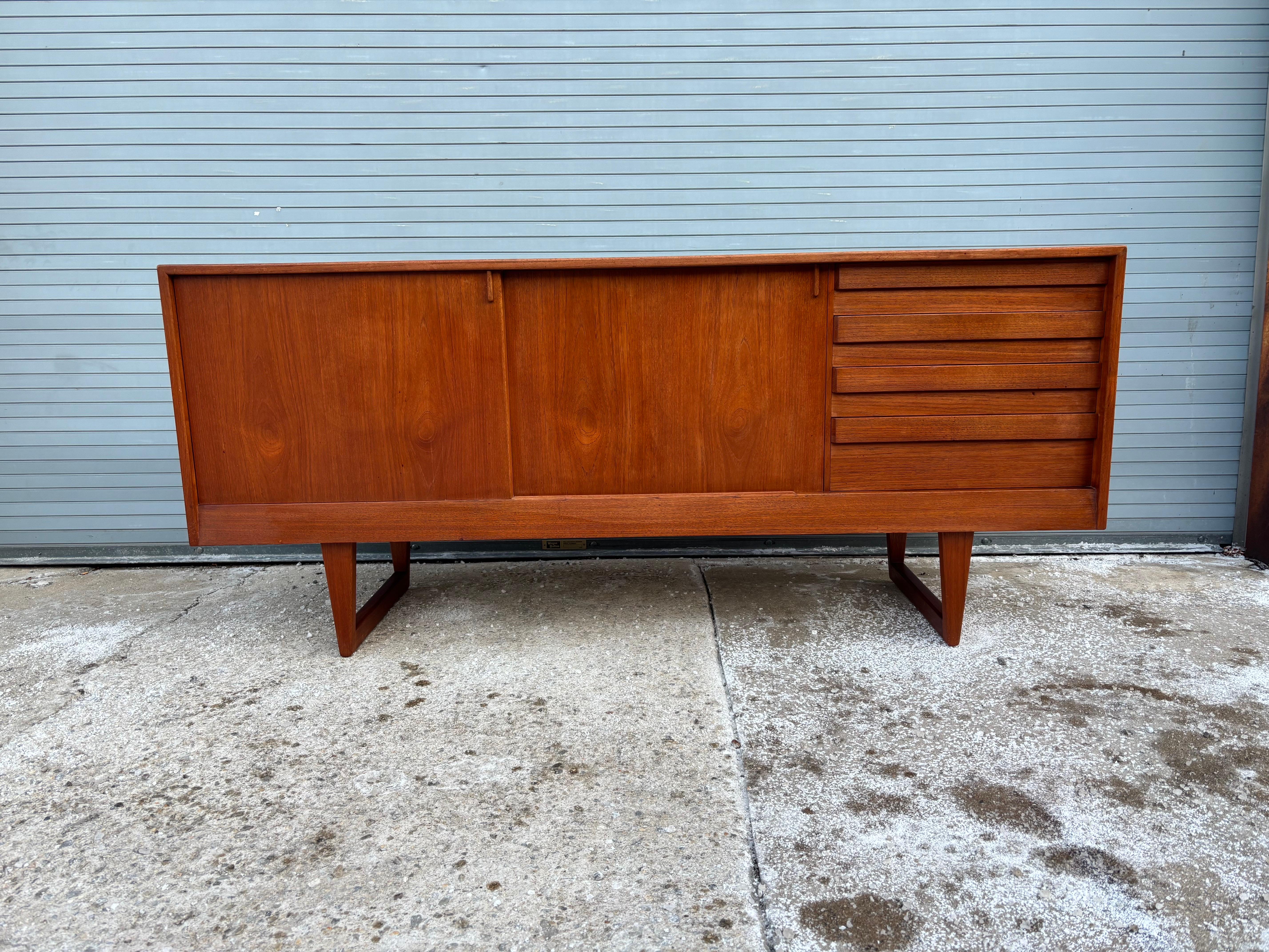 Kurt Ostervig Teak Credenza.  Sliding doors reveal a birch interior.  Nice Size and Scale with doors on left and pull out drawers to the right.  Dovetailed construction and velvet to the top drawer.  Overall very clean!  Slight shadow to top where