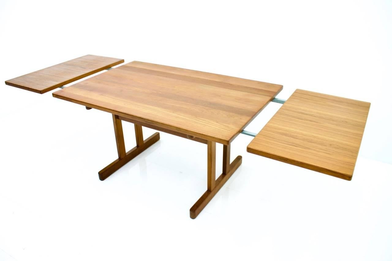 Teak wood dining table by Kurt Ostervig for KP Mobler, Denmark, 1960s. The table comes with two extensions plates. 

Measures: Wide 140 cm (55.1 inches) + two extensions with 50 cm (19.7 inches) each.

Very good condition.


 