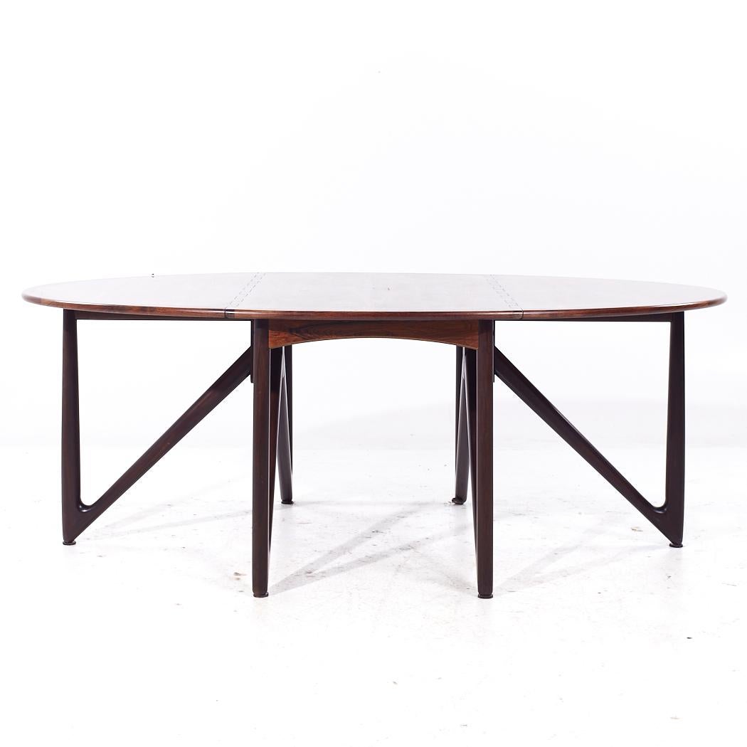 Kurt Østervig for Jason Furniture Mid Century Danish Rosewood Drop Leaf Dining Table

This table measures: 28.5 wide x 51.25 deep x 28.5 inches high, with a chair clearance of 27.5 inches, each drop leaf measures 24 inches wide, making a maximum