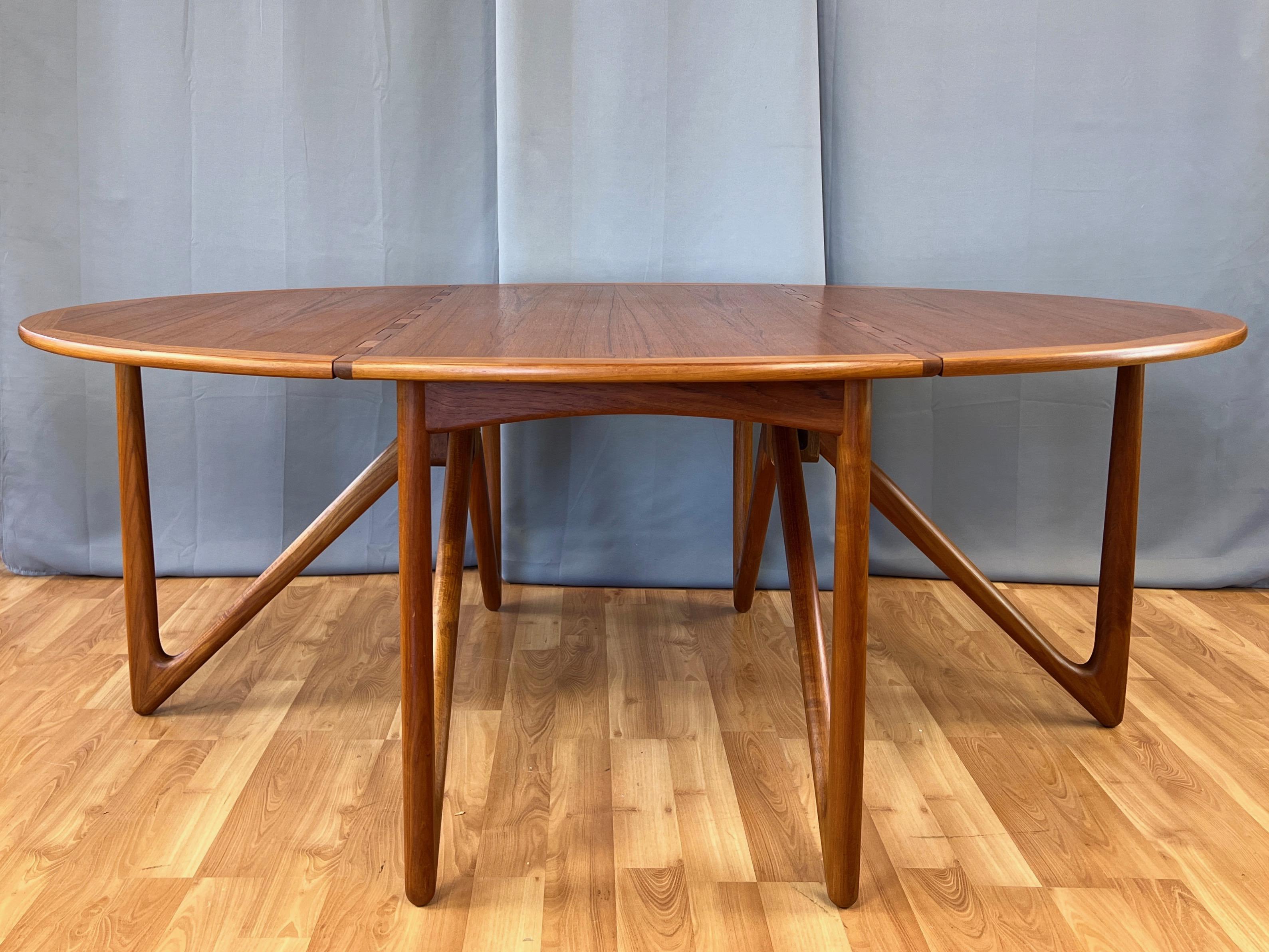A stunning 1960s teak drop-leaf dining table by Kurt Østervig for Jason Møbler.

Notable for elevating the quotidian hinge to an aesthetically striking design element. Equally impressive are the handsomely V-shaped swing-out solid teak legs, which