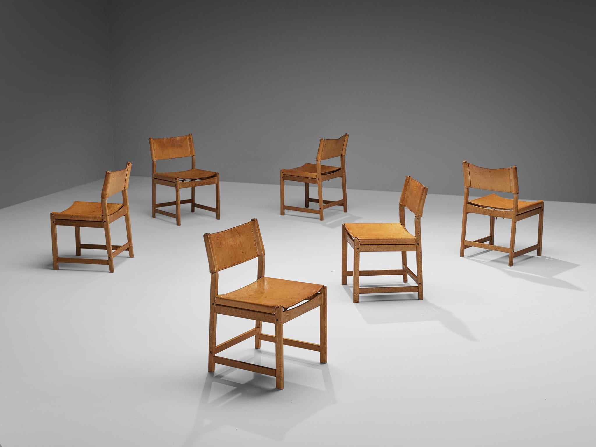 Kurt Østervig for Sibast, set of six dining chairs, cognac leather, oak, Denmark, 1960s. 

These characteristic chairs are made in solid oak, with seating and back from thick cognac leather. The lines and forms are simple, yet with the right