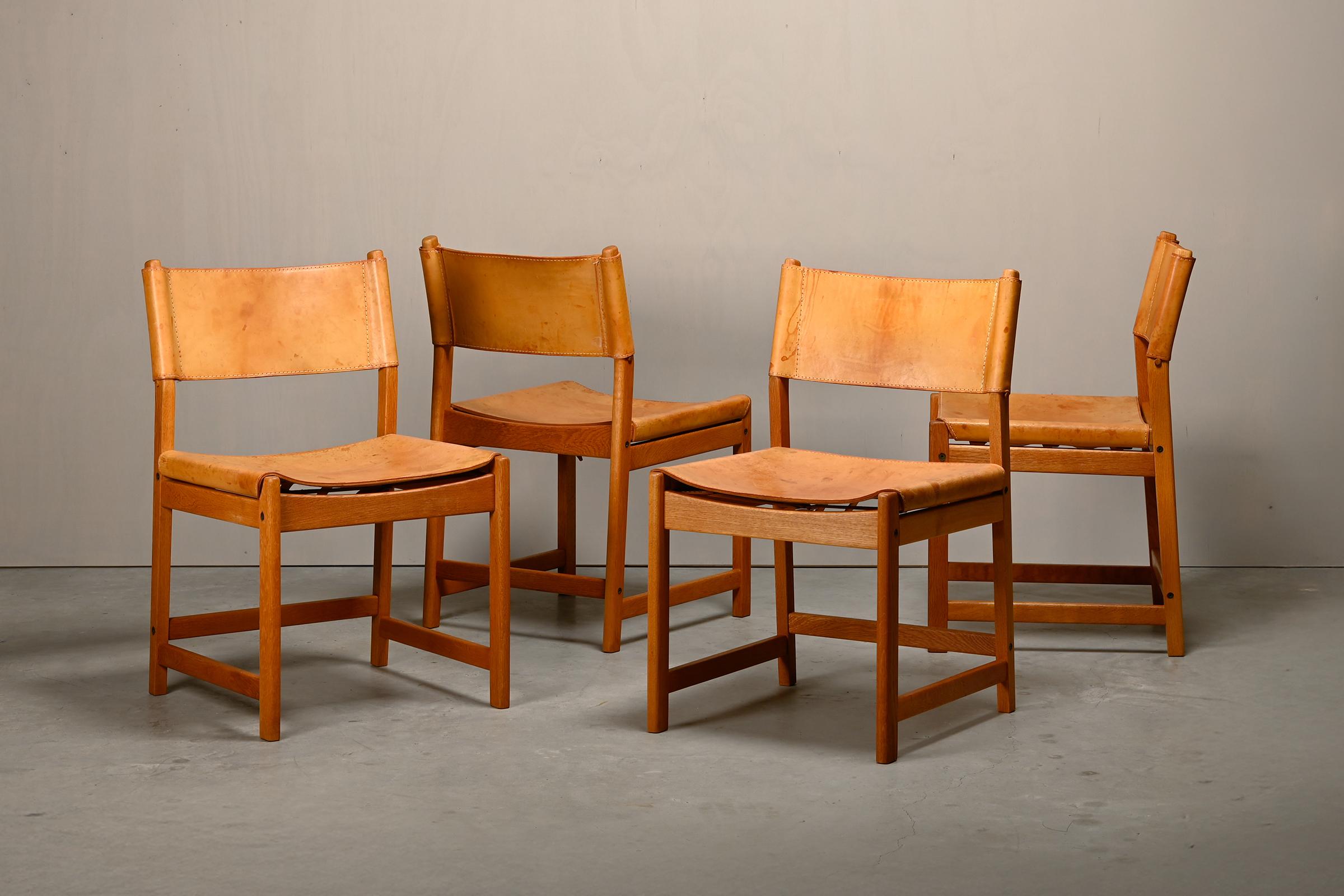Hunting Dining Chair set designed by Kurt Østervig for KP Møbler, Denmark 1960s. Solid oak frames with beautiful warm wood grain and thick cognac-coloured patinated saddle leather seats. Simple elegant lines with excellent seating comfort. All in