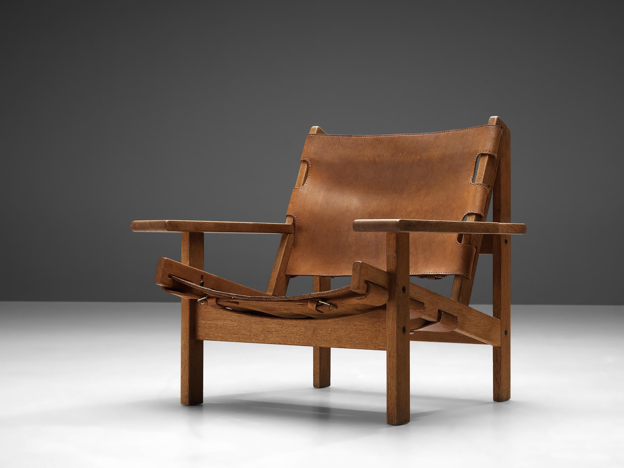 Kurt Østervig for K.P. Jørgensens Møbler, 'Hunting' armchair, model '168', oak, leather, metal, Denmark, 1960

This lounge chair shows exquisite Danish craftsmanship and aesthetics. It features traits of hunting chairs by means of its strong, sturdy
