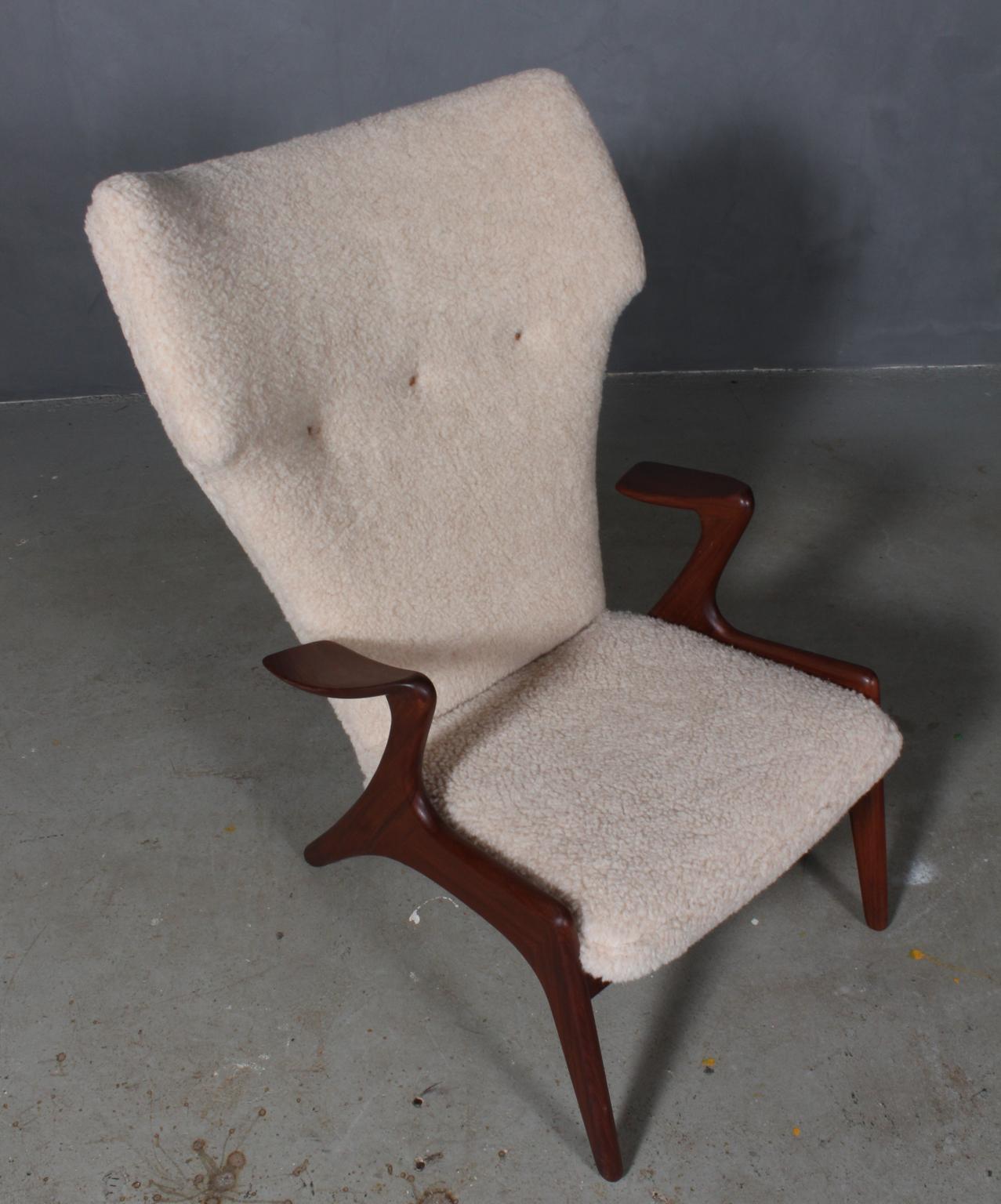 Kurt Østervig lounge chair new upholstered with sheepskin with buttons of leather.

Organic shaped frame of solid teak.

  