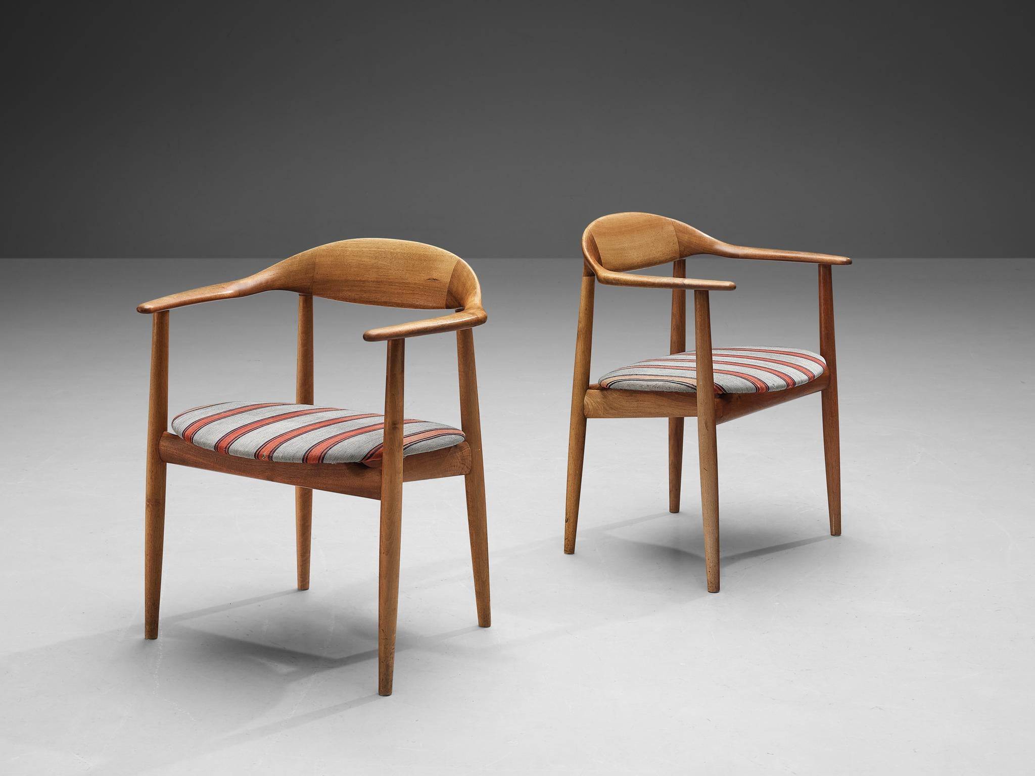 Kurt Østervig for Brande Møbelindustri, armchairs, model '27', walnut, fabric, Denmark, 1950s. 

This organic looking pair of armchairs are made with an outstanding attention to detail as seen in the finish of the wooden joints. Executed in the