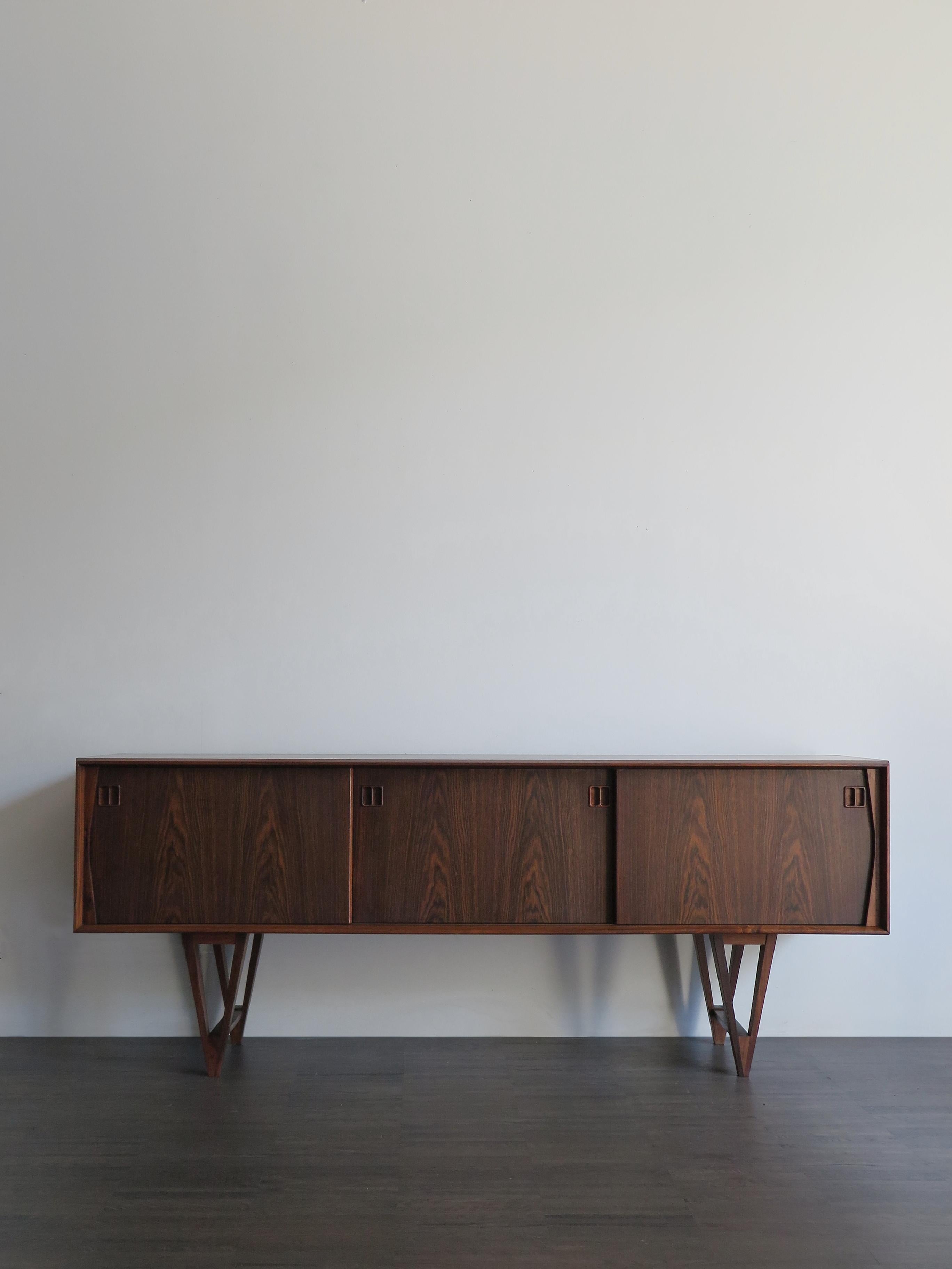 Scandinavian Mid-Century Modern design dark wood sideboard designed by Kurt Østervig for K. P. Møbler with sliding doors and retractable drawers, produced in Denmark from circa 1950.

Please note that the item is original of the period and this