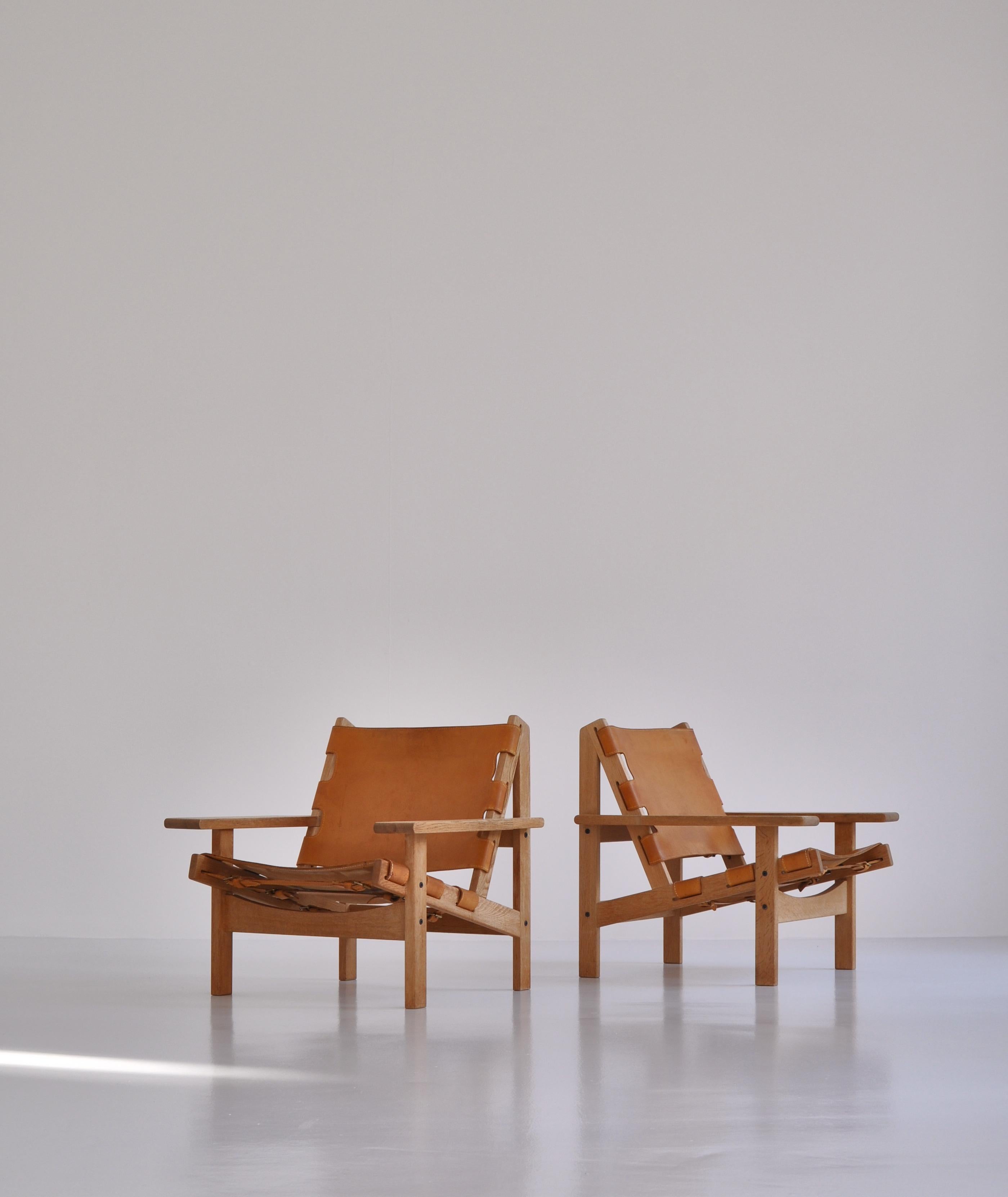 Rare pair of hunting chairs in oak and saddle leather manufactured by KP-Møbler (KP-furniture) in the 1960s. Made by Danish architect Kurt Østervig. All original condition with beautiful rich patina to both oak and leather.