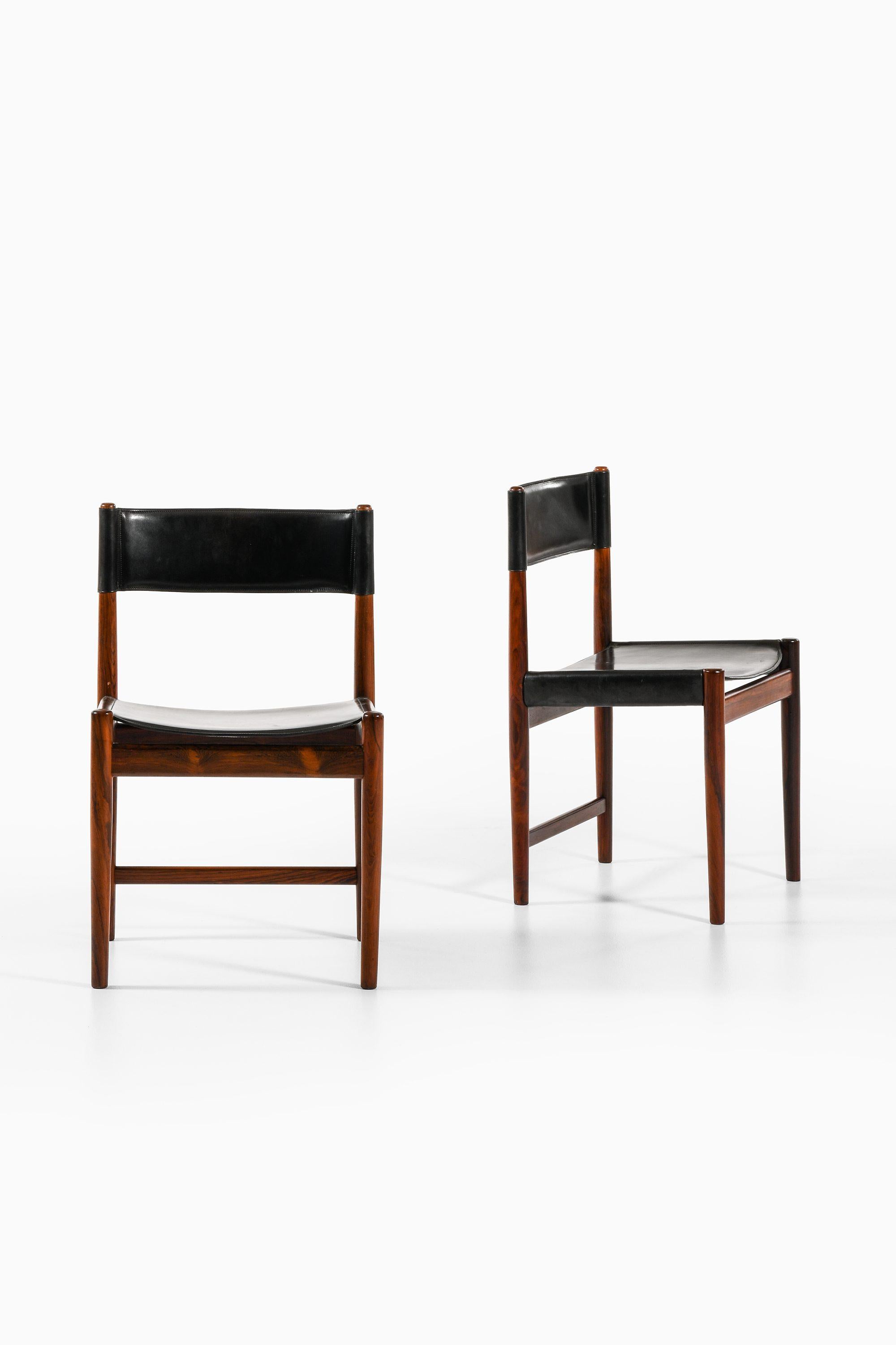 Set of 6 Dining Chairs and 2 Armchairs in Rosewood with Black Leather by Kurt Østervig, 1960's

Additional Information:
Material: Rosewood and black leather
Style: Mid century, Scandinavian
Produced by Sibast møbelfabrik in Denmark
Dimensions (W x D