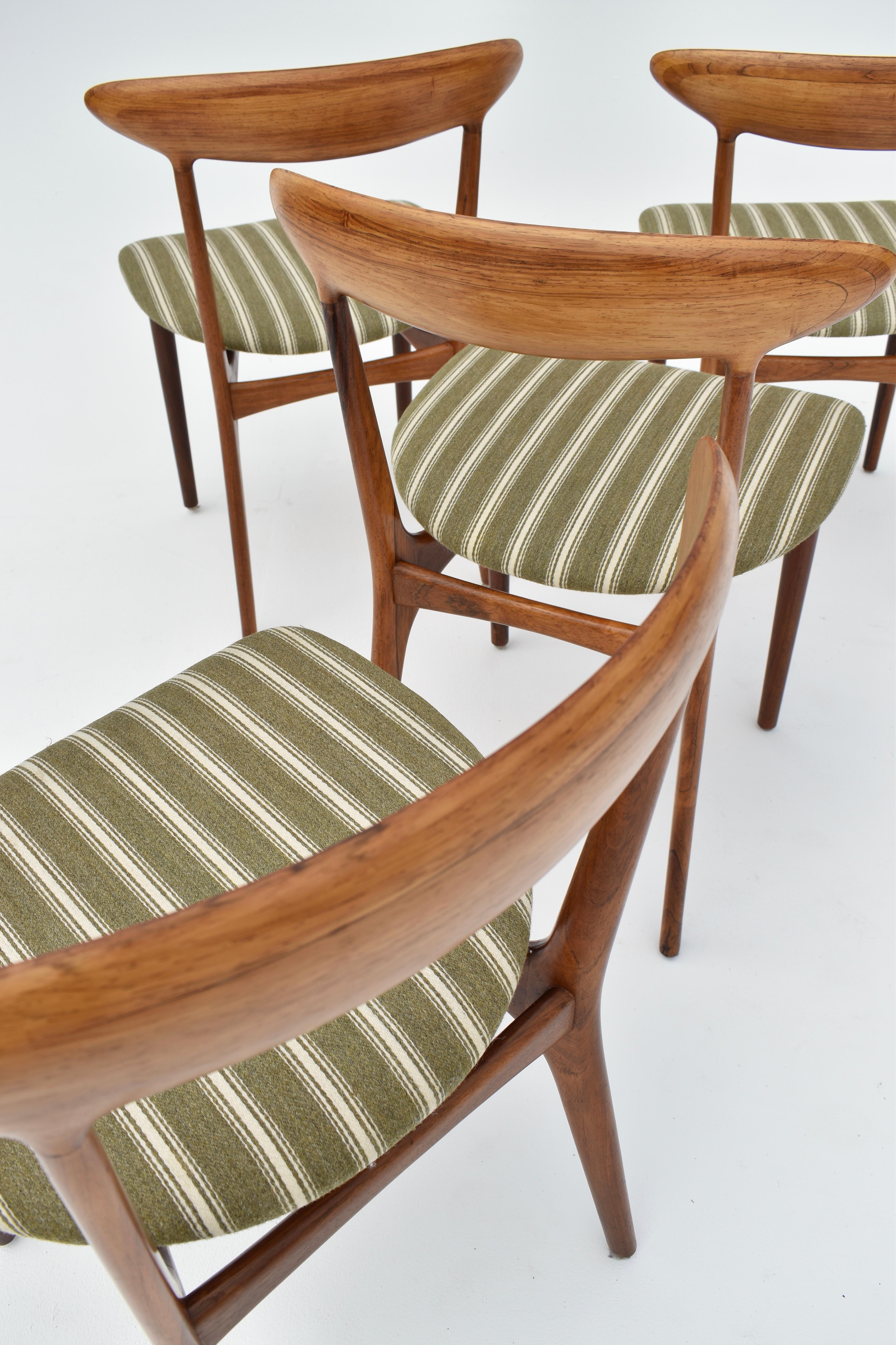 Exquisite and rarely seen dining chairs designed in 1955 by Kurt Østervig for Brande Møbelindustri.

A very pretty and elegant design with a wonderful organic form. This set of four is a true set with consecutive veneers to the backrests. The