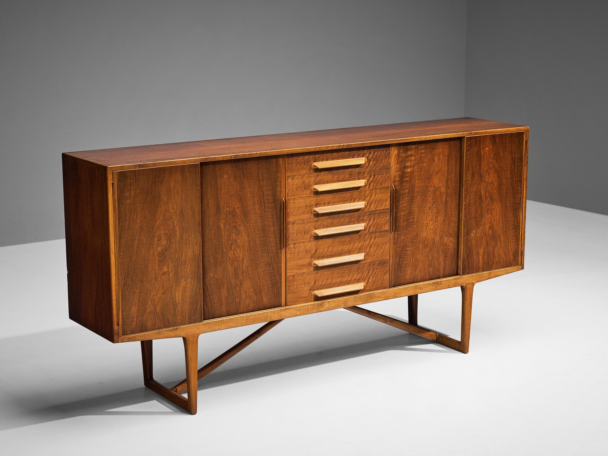 Kurt Østervig, sideboard, walnut, Denmark, 1950s

Sophisticated walnut sideboard by Kurt Østervig. The quality of this piece is reflected in the very well made seamless wood joints and door grips, as well as the warm grain of the walnut veneer. The