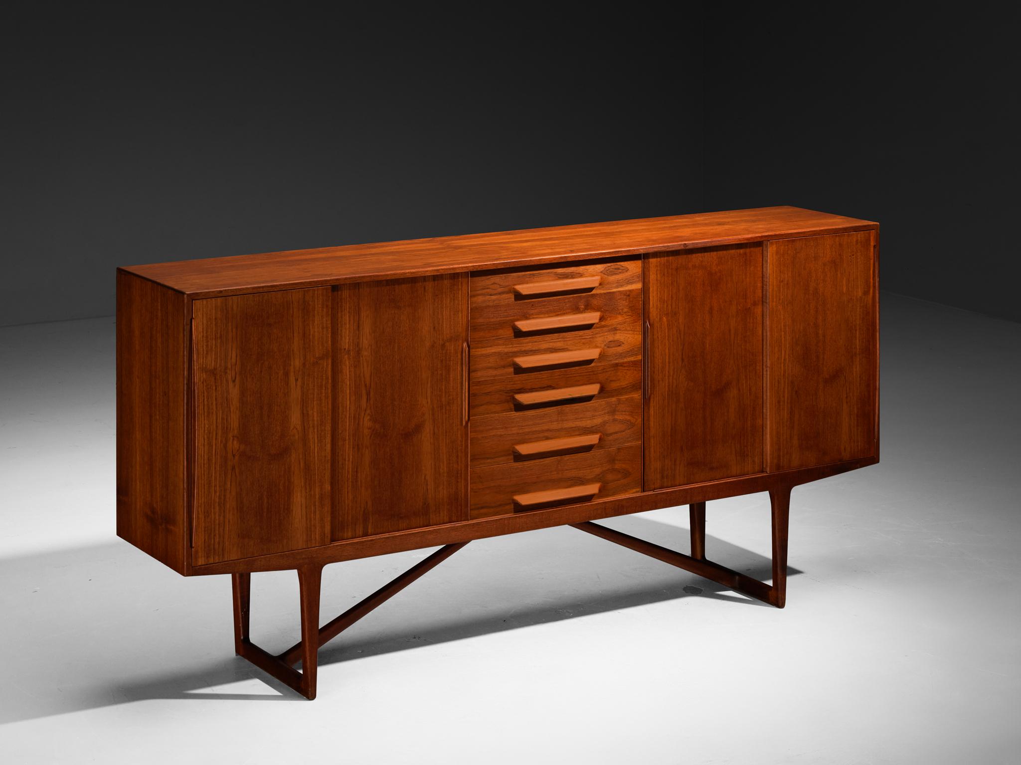 Kurt Østervig, sideboard, walnut, Denmark, 1950s

Sophisticated walnut sideboard by Kurt Østervig. The quality of this piece is reflected in the very well made seamless wood joints and door grips, as well as the warm grain of the walnut wood used to
