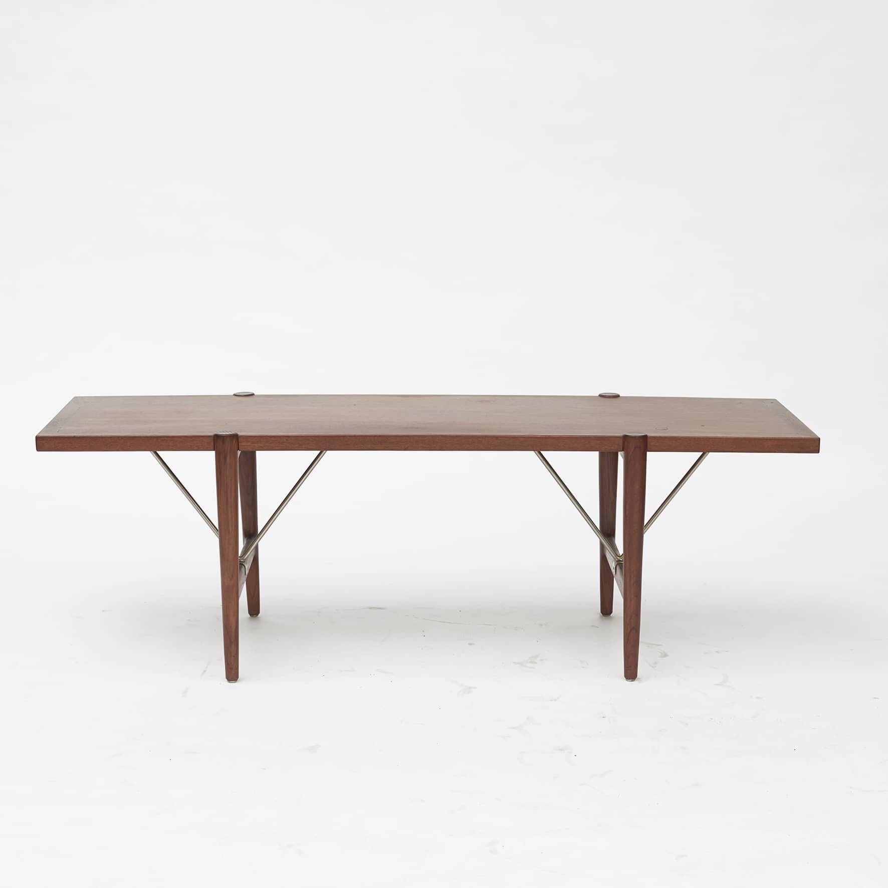 Kurt Østervig 1912-1986.
Teak coffee table with chrome-plated brass stretchers.
Designed and manufactured 1960-1965.