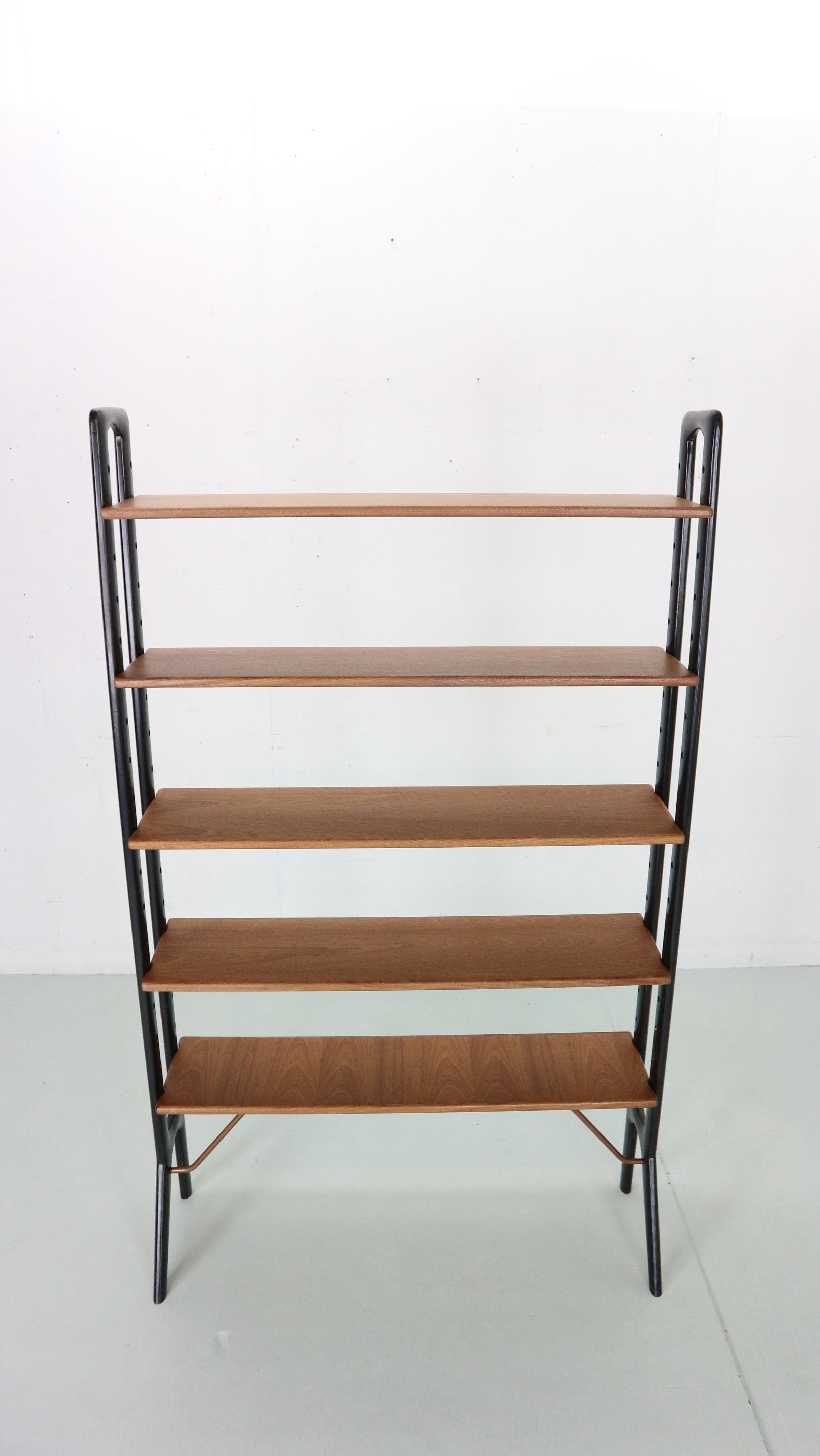 Scandinavian modern period free standing bookshelf or room divider designed by Kurt Østervig for K.P. Møbler makers in 1960's Denmark.
High quality danish furniture shelving unit made of teak wood with brass support structure ( witch has been