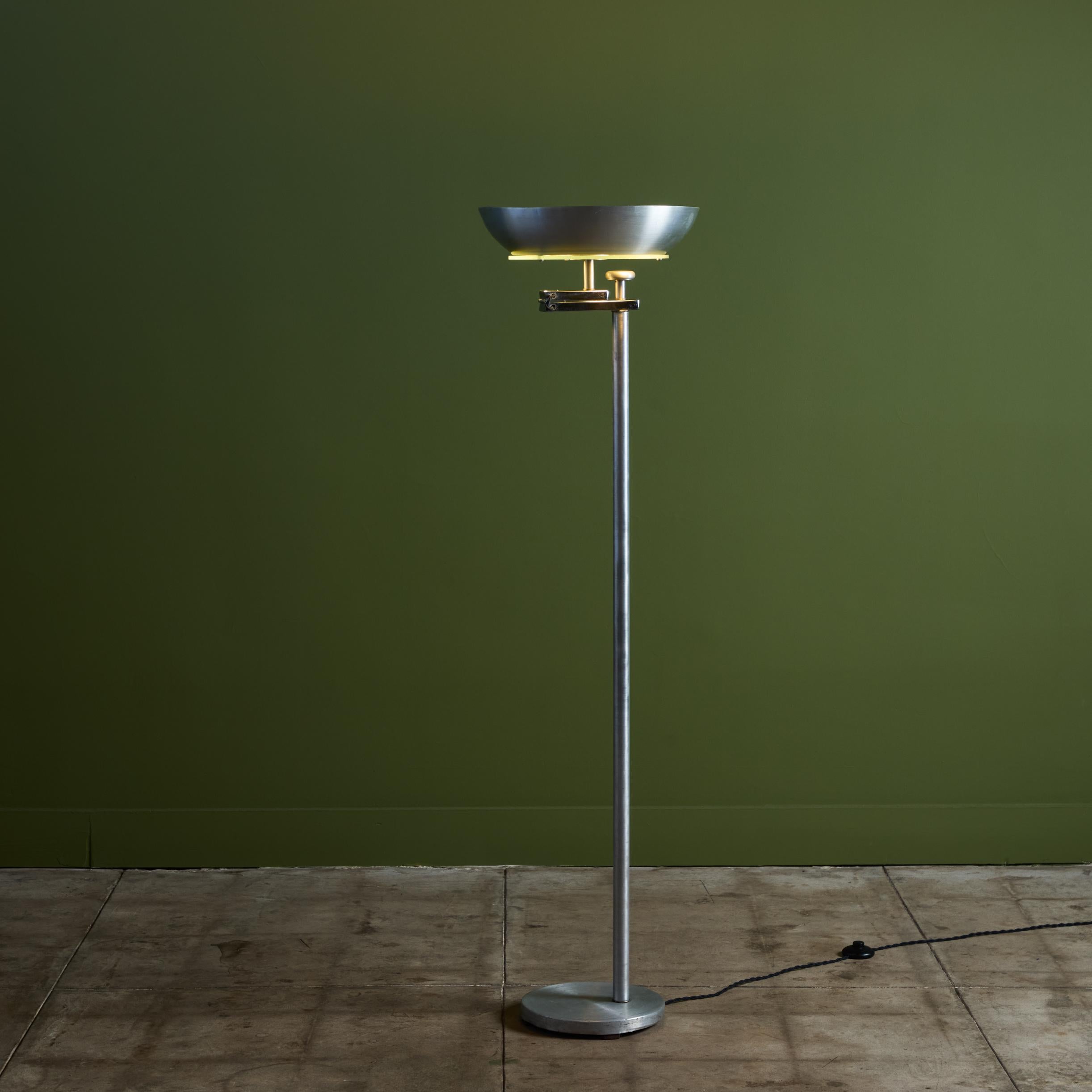 Kurt Versen aluminum floor lamp, USA c.1950s. The lamp features an aluminum base and stem with a round spun aluminum and glass shade. When the shade is flipped the depth of the lamp is extended and the light is diffused downwards rather than