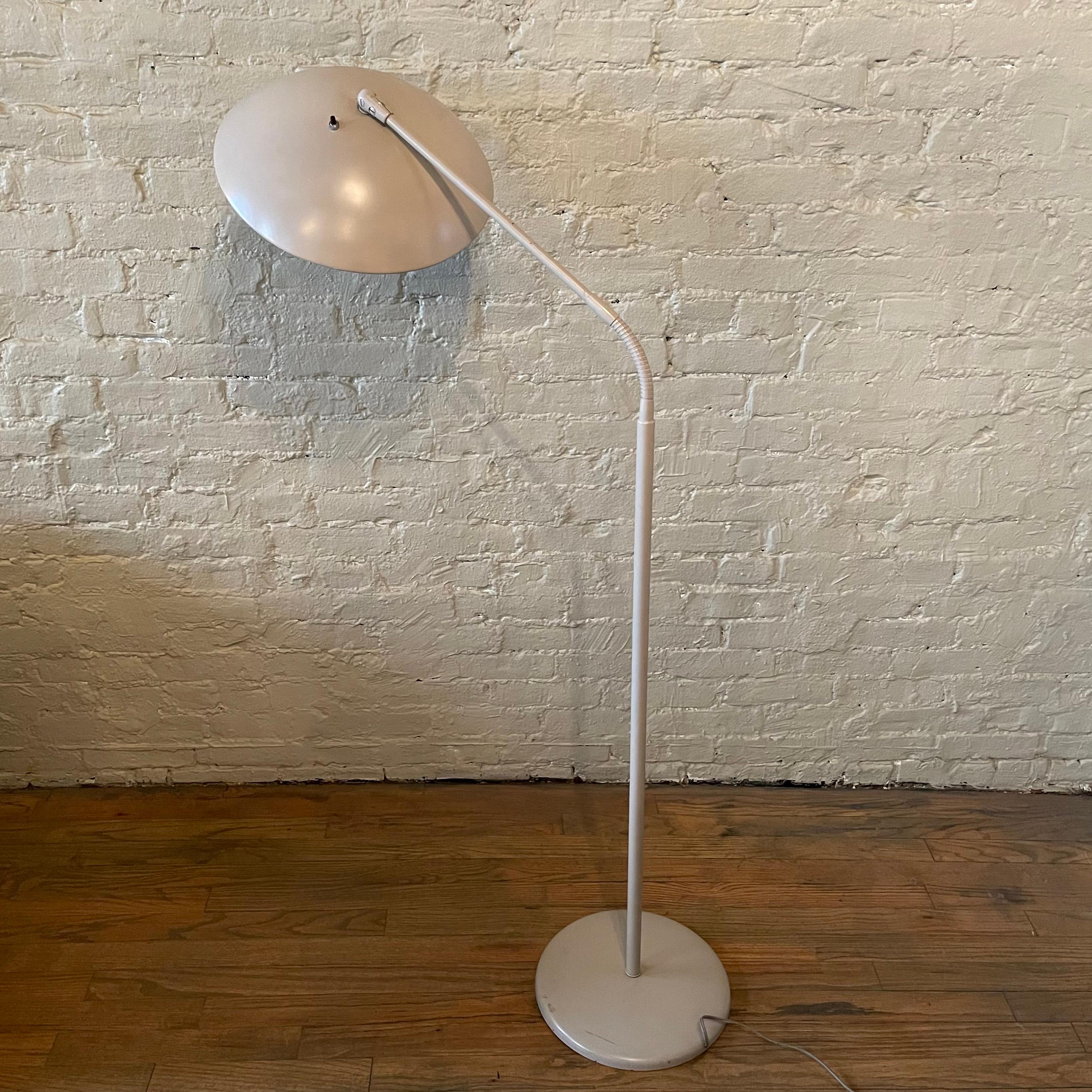 Mid-Century Modern, articulating, gooseneck, painted metal, floor lamp designed by Kurt Versen functions in a variety of ways. When adjusted down, with an overall reach of 30 inches, it's a reading lamp. When fully extended it's an uplight,