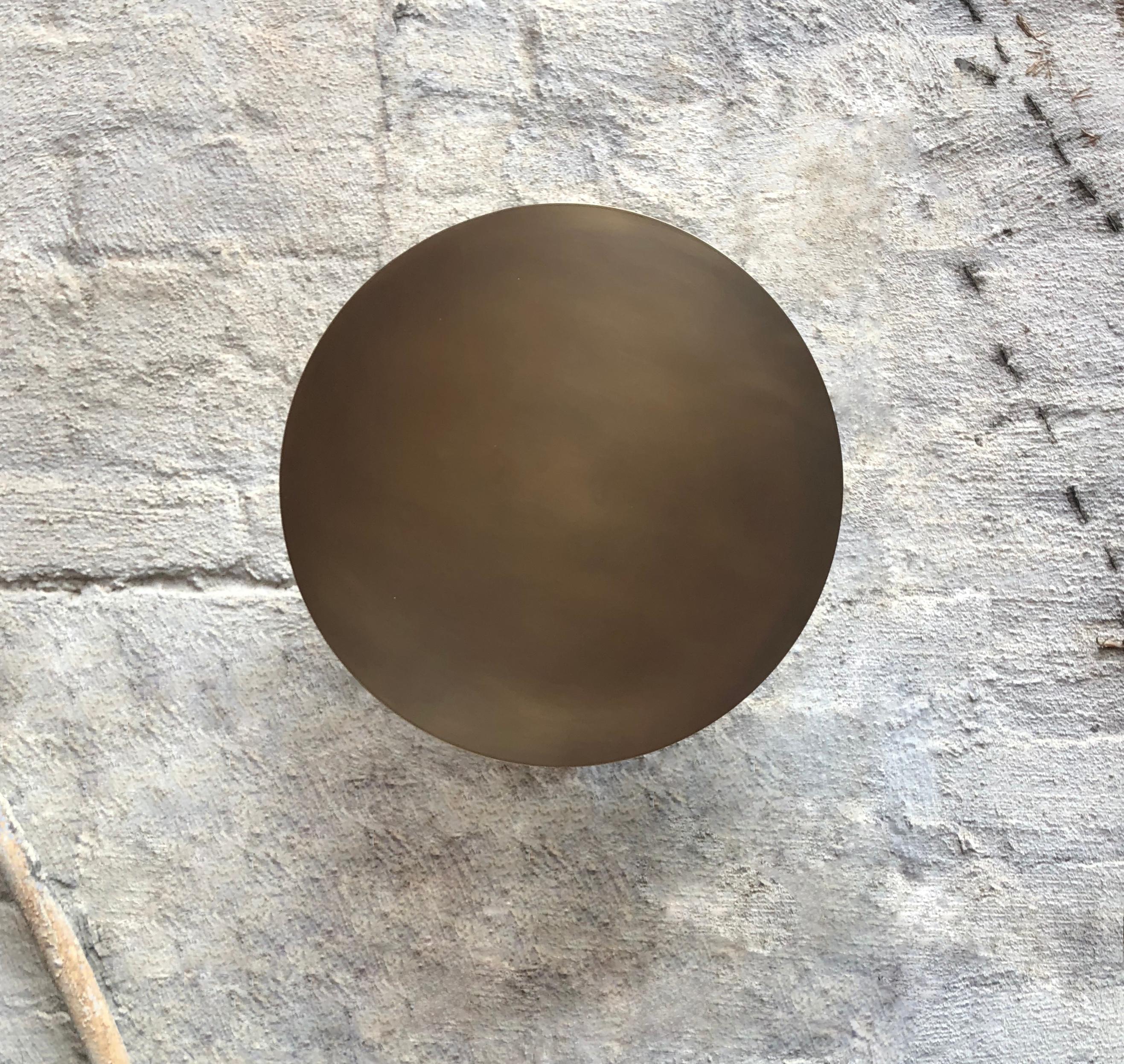 Kurt Versen designed ceiling or wall indoor lights in patinated brass of a sturdy gauge. Each fixture has a round, straight edge shade that is enameled white on the interior side and is affixed onto the white enameled brass cylindrical stem and
