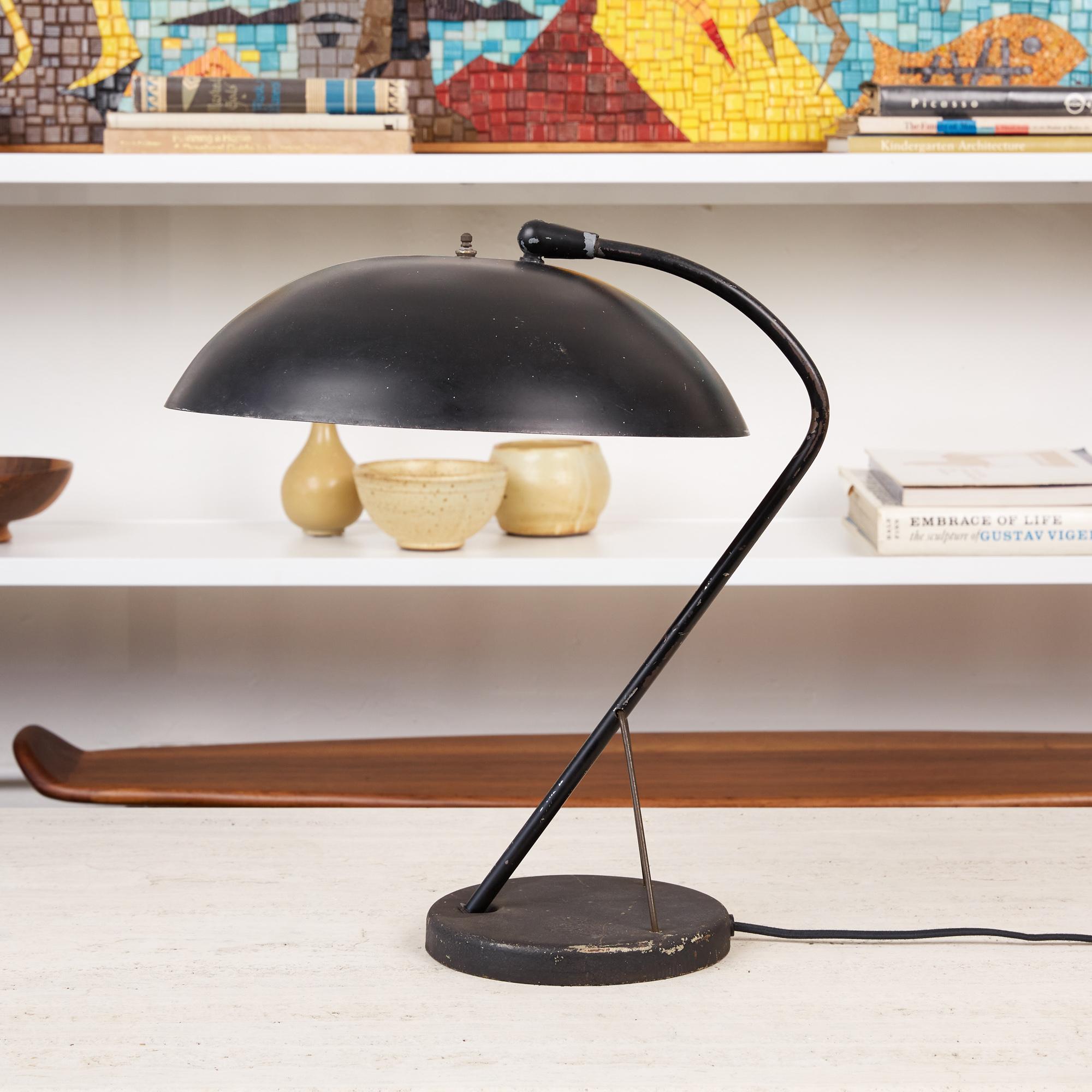 Kurt Versen desk lamp, USA, circa 1950s. This table lamp by Modernist American lighting designer Kurt Versen is one of his more rare and desirable designs. It features a Minimalist enameled black steel body and shade. The dome shaped shade is