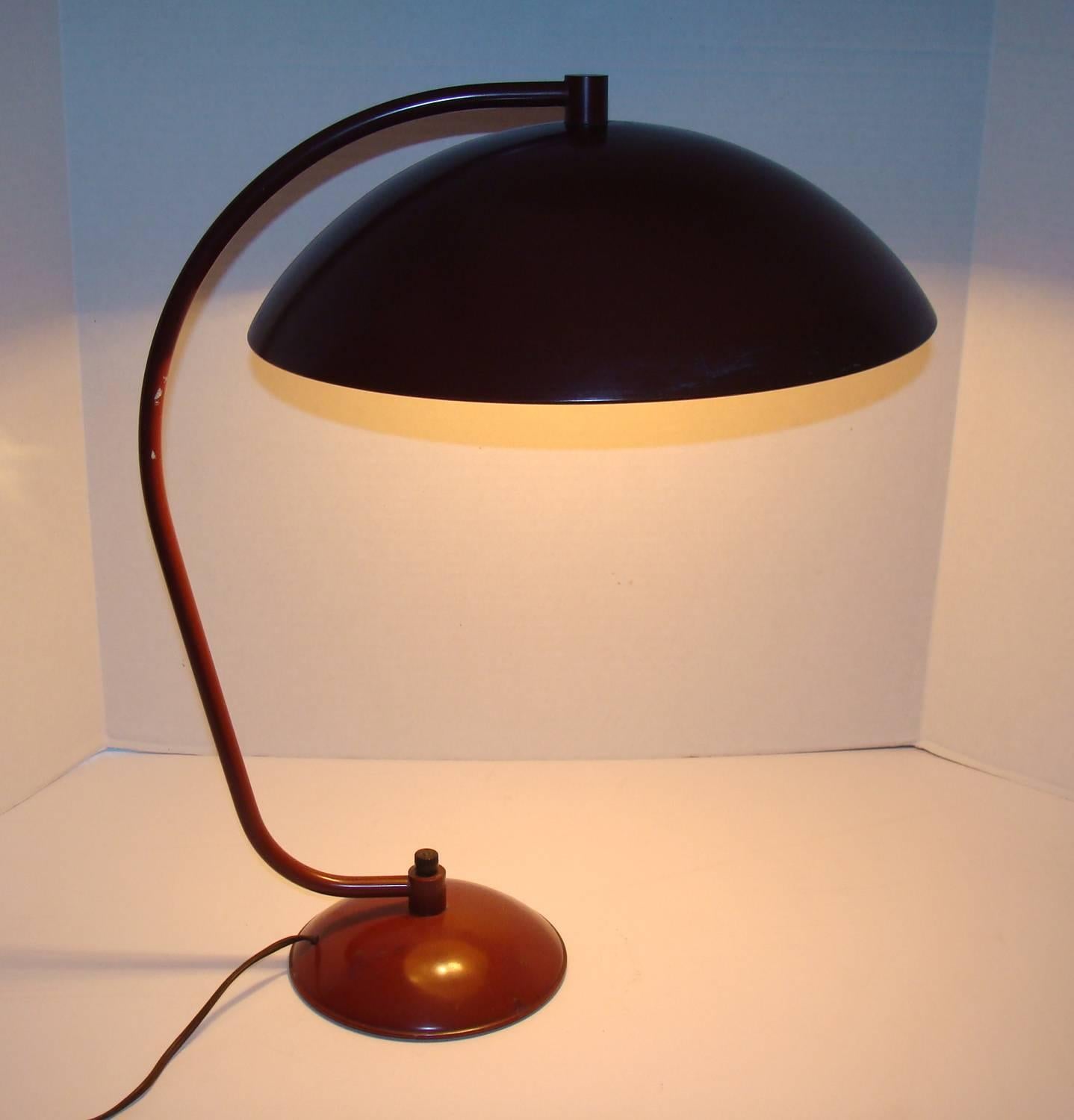 One of our favorite Versen designs. Hard to find in original condition. Dark red enamel exhibits very minor wear. Old wiring is usable but re-wiring is always recommended. Two porcelain sockets uses standard base lightbulbs.
Shade and base in