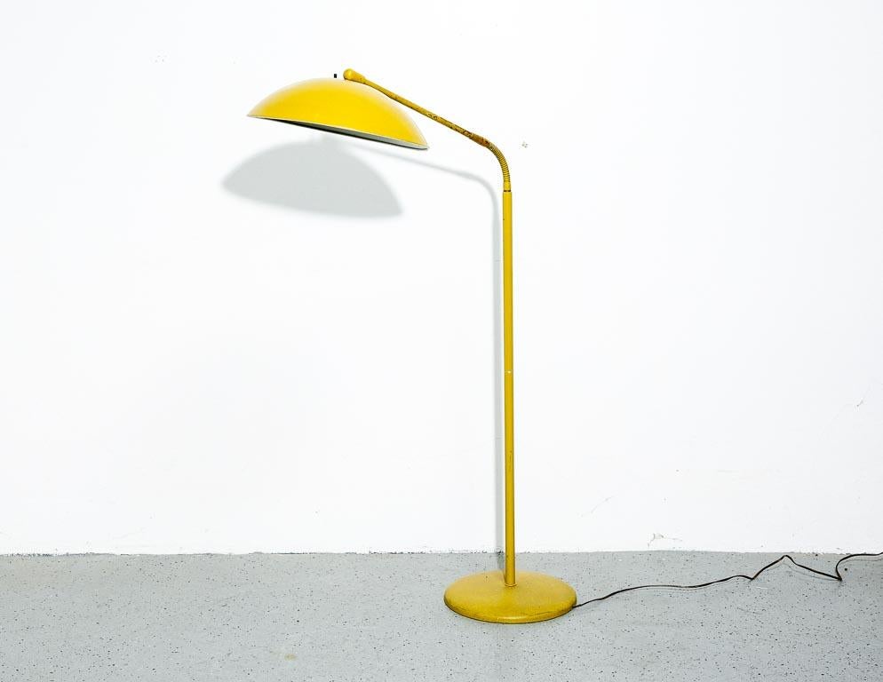 Vintage floor lamp deigned by Kurt Versen in mustard yellow. Gooseneck with large saucer shade.