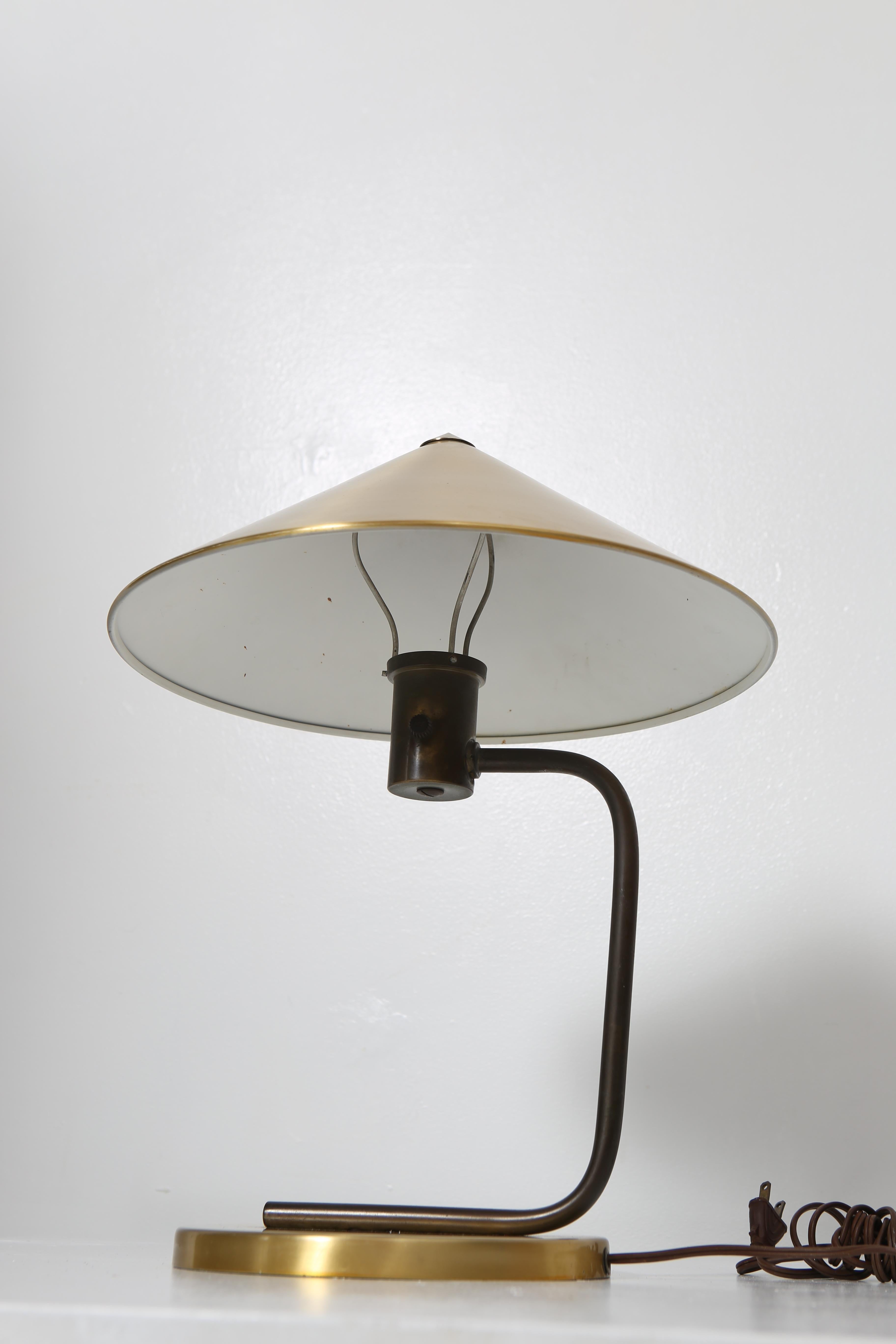 Fantastic early lamp by Swedish-born designer, Kurt Versen. In brass with plated aluminum shade. Excellent condition. Rare lamp. United States, 1930s. 18” tall.