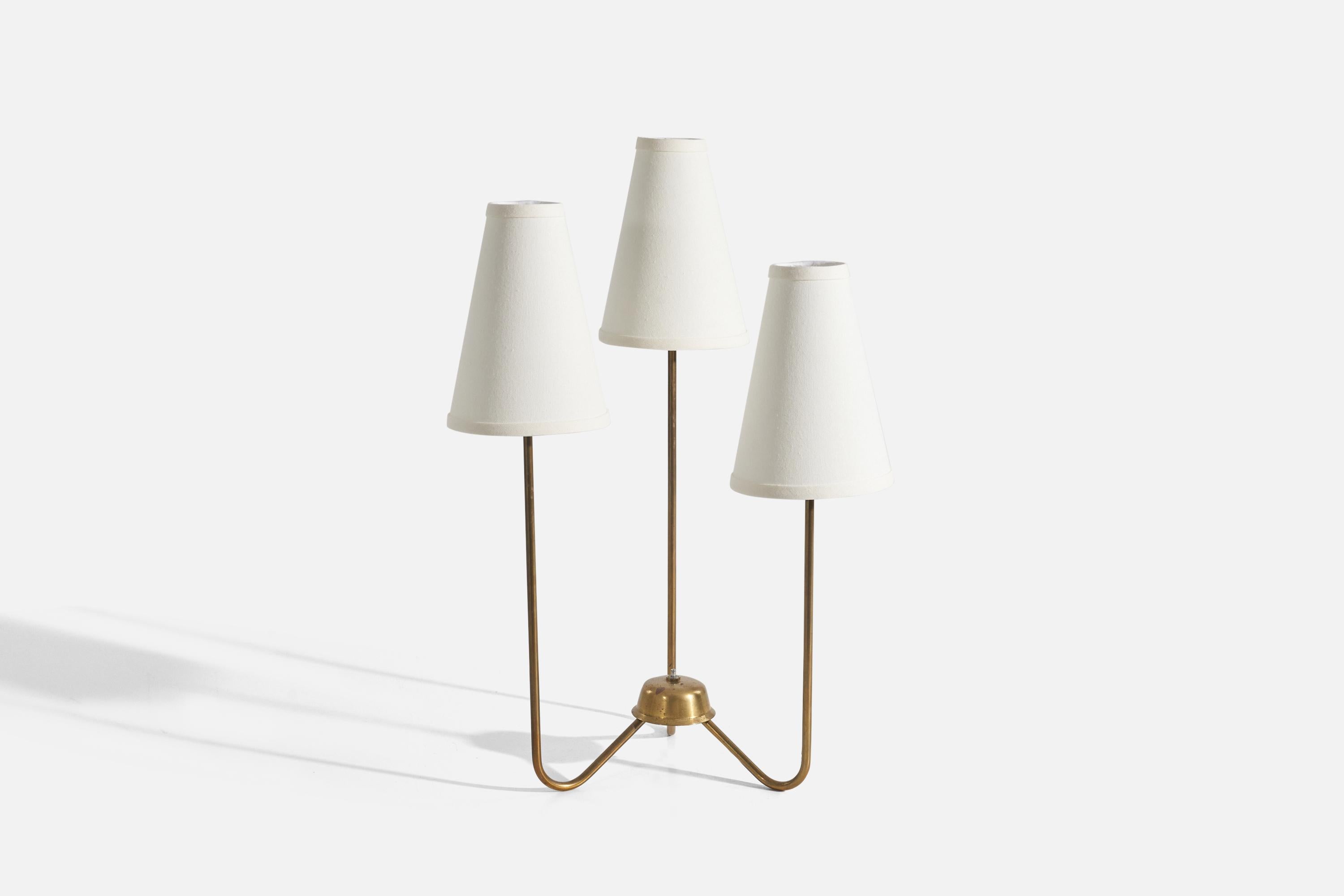 A three-armed brass and fabric table lamp designed by Kurt Versen and produced by his own firm, Kurt Versen Inc, United States, 1950s. 

Sold with Lampshade(s). Dimensions stated are of Lamp with Shade(s). 

Socket takes standard E-26 medium