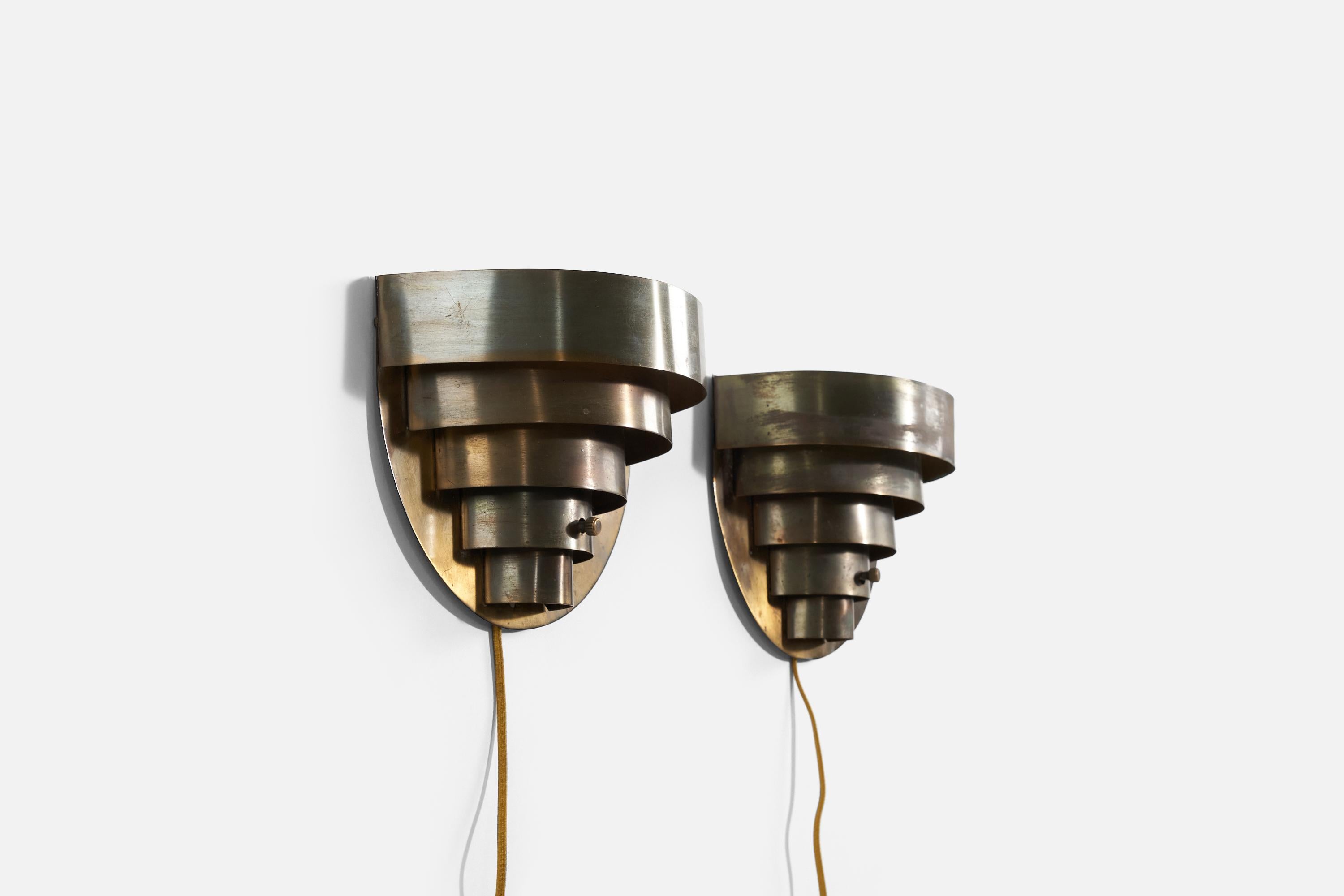 A pair of brass wall lights produced by Kurt Versen, United States, 1950s.