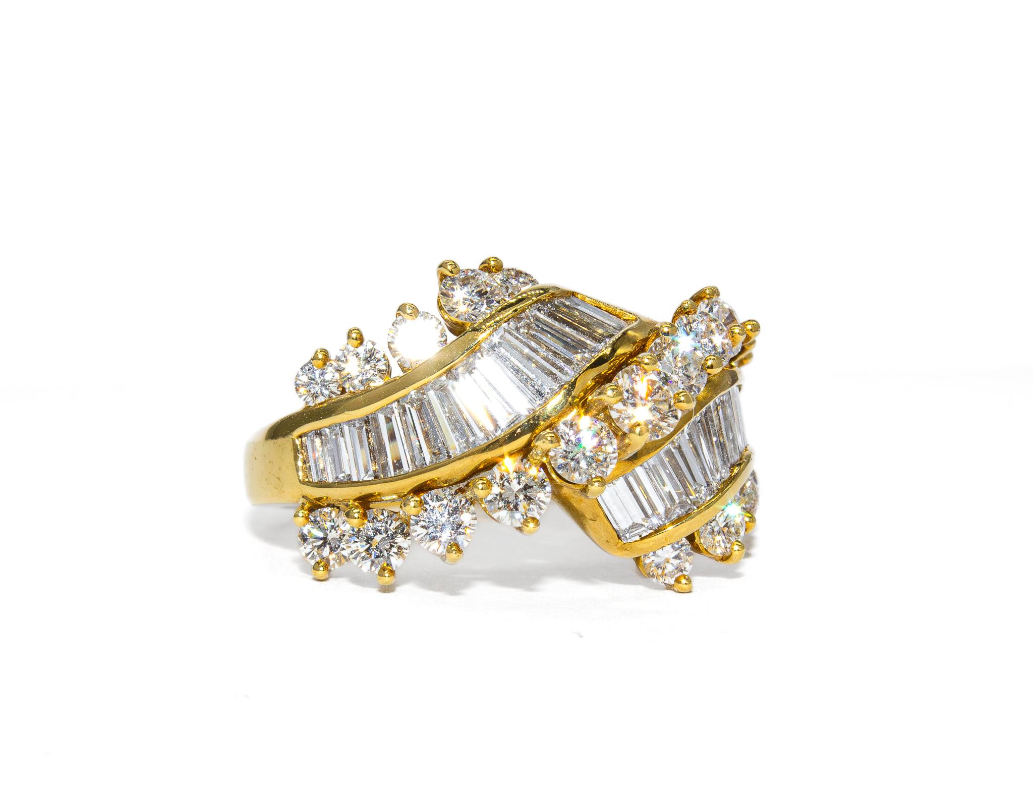 This vintage ring by renowned designer Kurt Wayne blends warmth, sparkle, and timeless sophistication. Crafted in rich 18K yellow gold, the design features 1.00 carat total weight of brilliant round diamonds and 1.27 carats of elegant baguette-cut