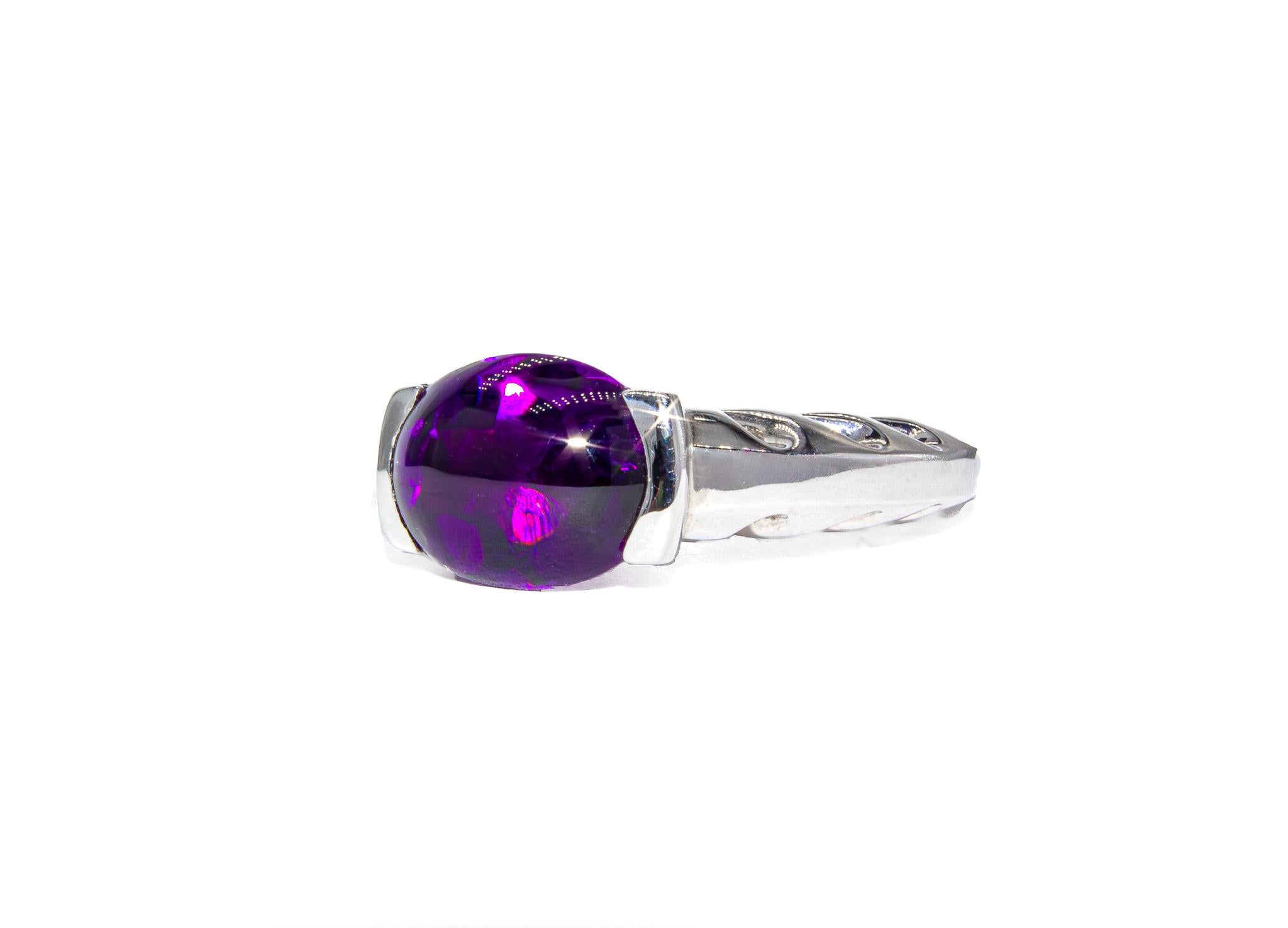 This elegant vintage ring by Kurt Wayne is a timeless celebration of color and craftsmanship. At its center is a 3.17 carat cabochon amethyst, set in a clean and modern bezel that lets the stone’s natural beauty take center stage. The amethyst’s