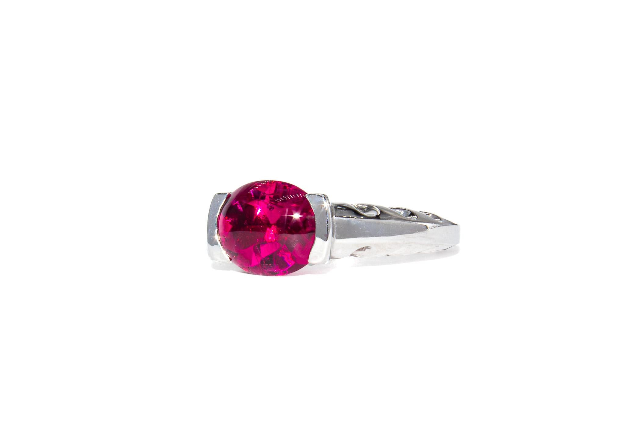 This bold and elegant ring by renowned designer Kurt Wayne showcases a vivid 3.35 carat rubellite cabochon in a smooth, high-domed cut that glows with rich raspberry tones. The stone’s glossy surface and saturated color are hallmarks of fine