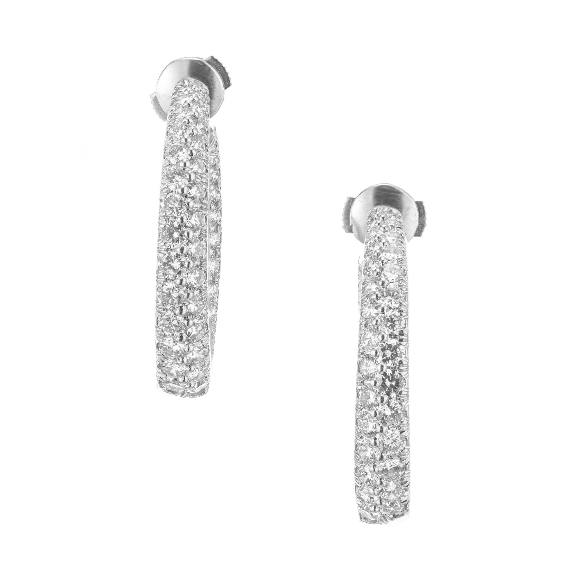 Kurt Wayne 3.50ct diamond platinum swirl hoop earrings are a dazzling display of elegance. These exquisite indie out, slightly twisted feature 112 ideal cut diamonds mounted in platinum with platinum earring backs. The swirling design adds a touch