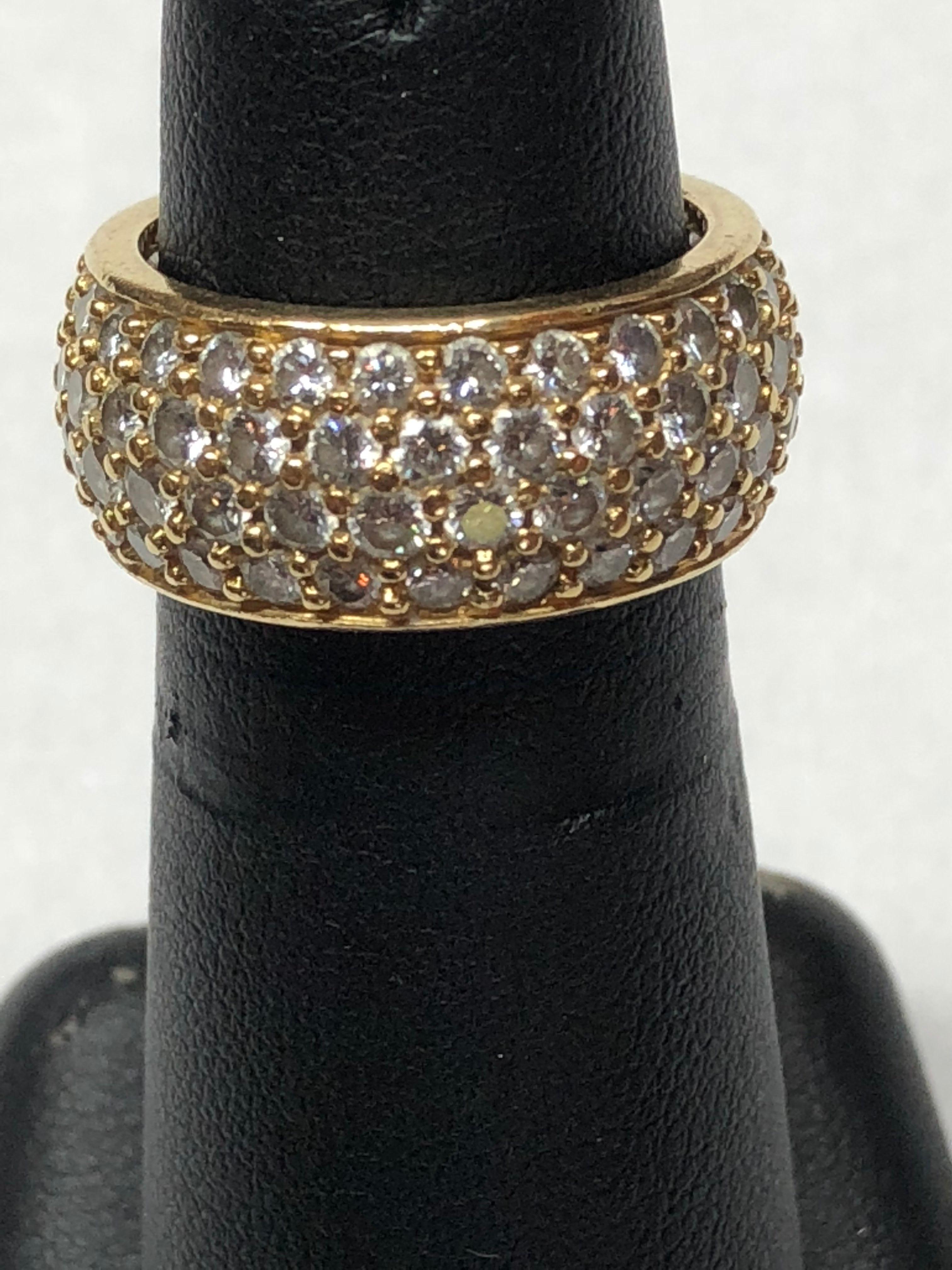 Lady's 18K yellow gold 4 row diamond eternity ring containing 104 brilliant cut diamonds of overall G color, VS1 clarity, weighing a total of 4.30 carats.  Manufactured by Kurt Wayne, Inc. Serial #119878.  Size 6.
