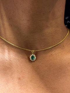 Kurt Wayne Oval Emerald Pendant with Diamond Halo in 18K Yellow Gold