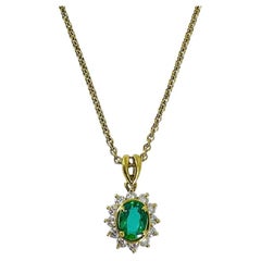 Kurt Wayne Oval Emerald Pendant with Diamond Halo in 18K Yellow Gold