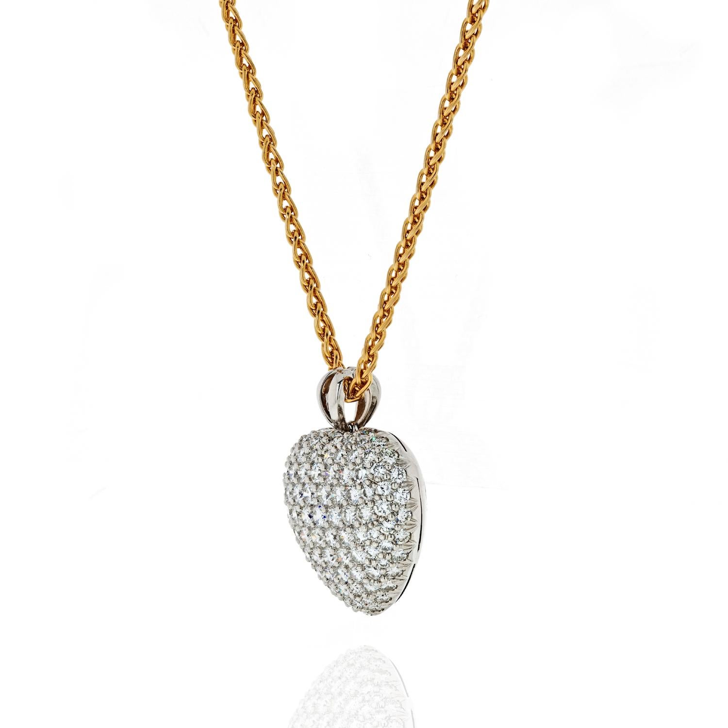 Platinum pave diamond heart pendant by Kurt Wayne. This diamond heart is of an exceptional quality encrusted with round brilliant cut diamonds of 5.50 carats total weight. 

Chain drops to about 21 inches. making this necklace a cool option for