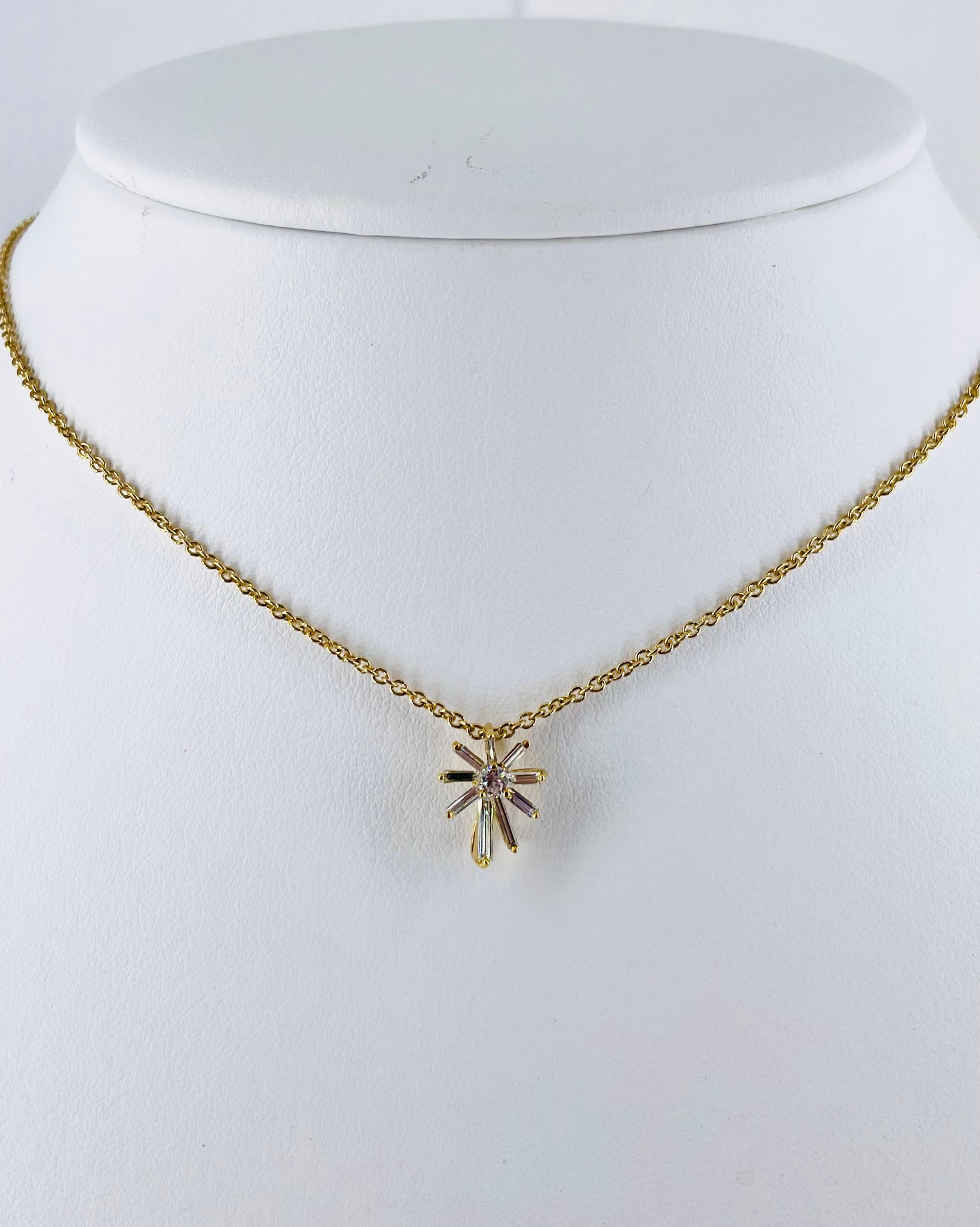 This charming and unique piece by Kurt Wayne features a 0.10ct round diamond and nine straight baguettes that form a graceful asymmetrical starburst design. The setting and chain are crafted in 14K yellow gold, and the chain is 16 inches long.