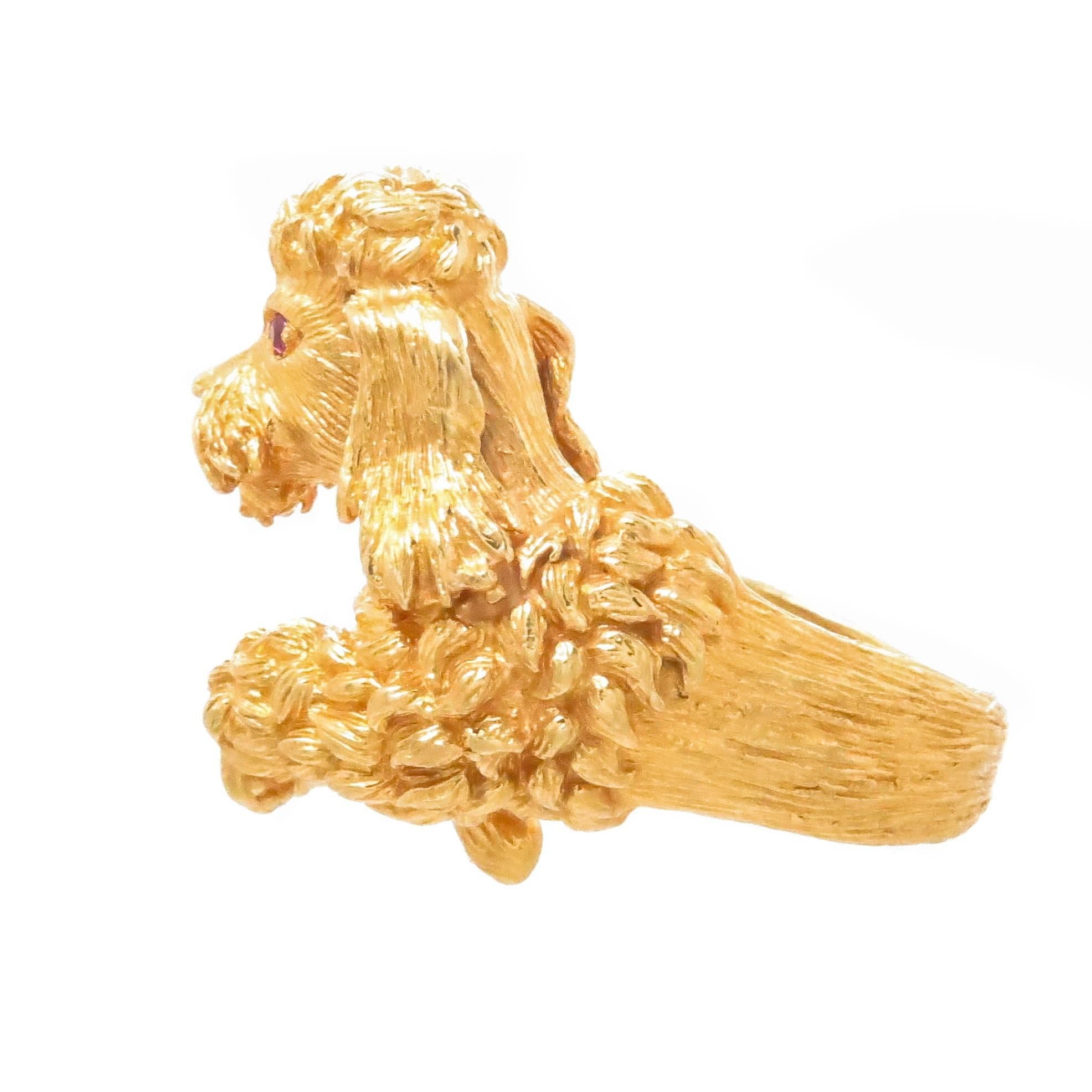 Circa 1980 Kurt Wayne 18K Yellow Gold Poodle Dog Ring,  very detailed and hand finished with fine texturing and also having Ruby set Eyes. The top measures 1 1/8 X 7/8 inch, nice solid construction and weighing 20.5 Grams. Finger size is 7 1/2. 