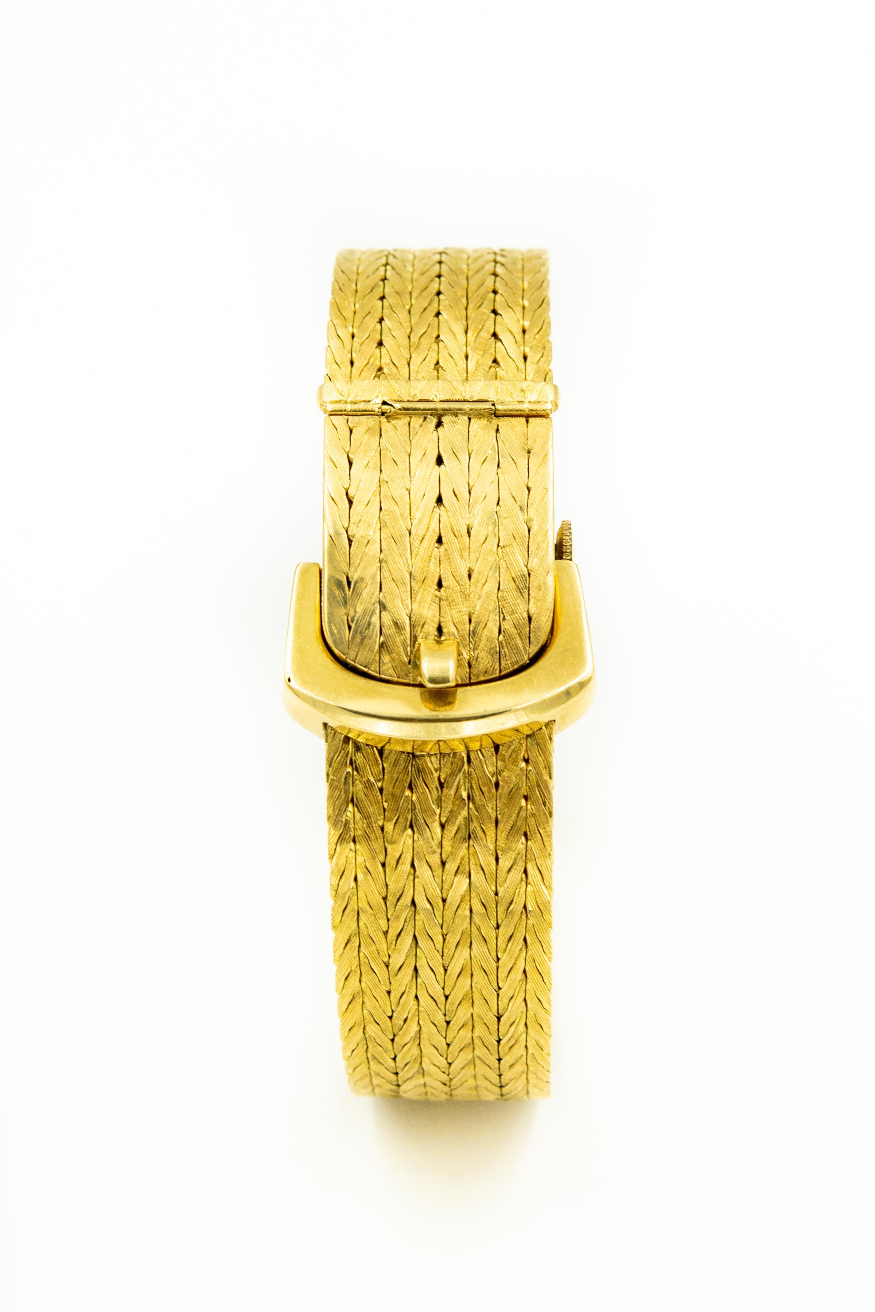 Stunning 18k yellow gold ladies watch by Kurz in Geneva featuring a buckle style covered watch with a braided or woven design band and cover.  The buckles hardware that the cover hinges from is a shiny finish.   The closure is a hinged that snaps