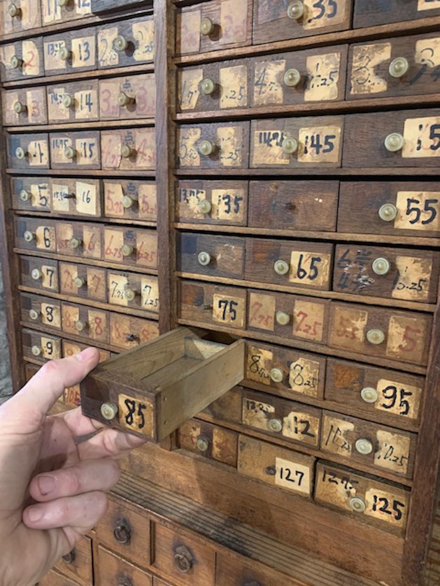 Kusuri Tansu, (Japanese Medicine Chest). Showa period, (1926-1989). This Japanese medicine chest from Shiga, Japan is completely original with old round polymer drawer pulls and numbered drawers used to identify locations of the medicinal herbs that