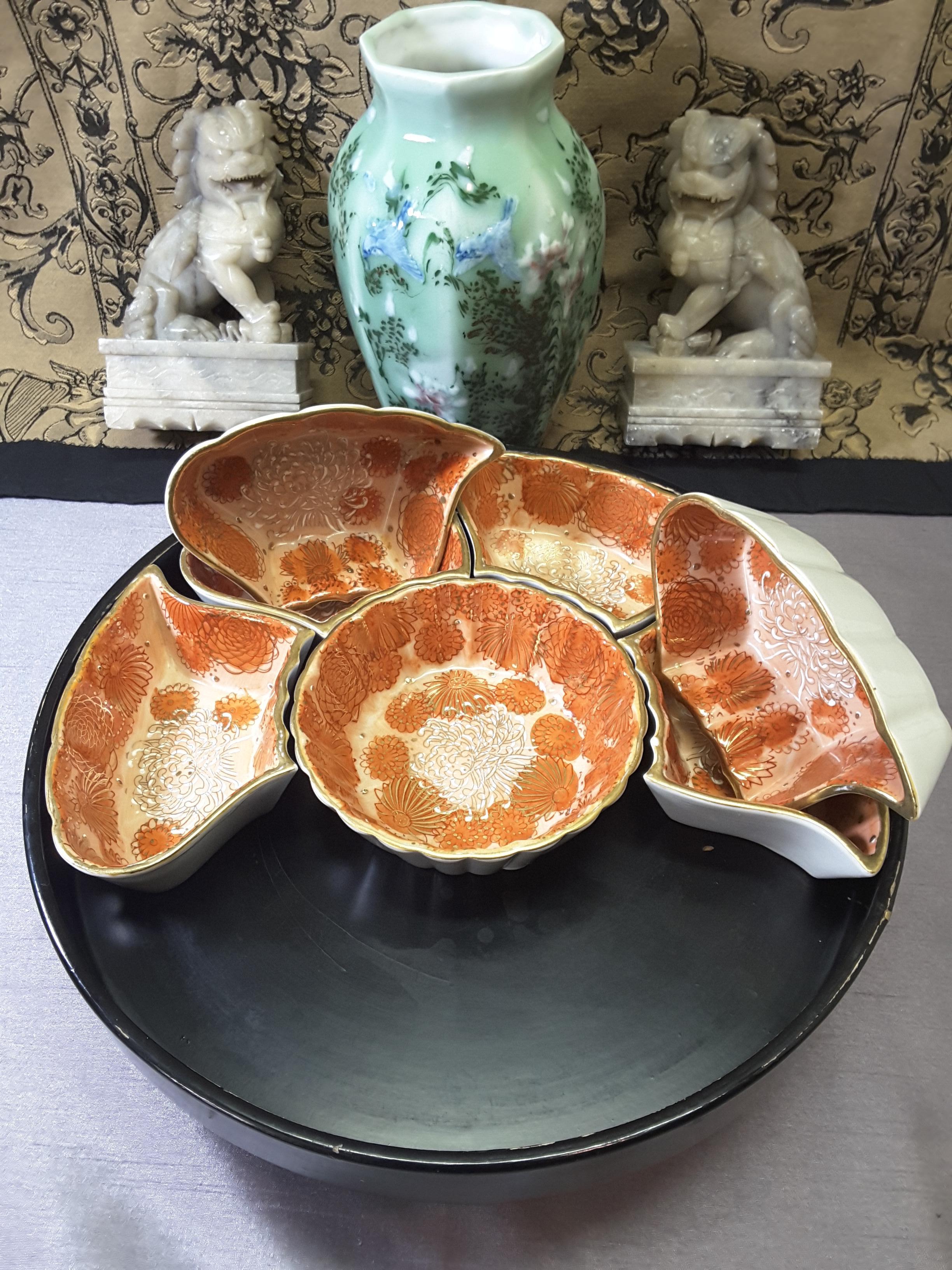 Kutani Japanese divided seven piece dish serving set on a lazy Susan rotating base, circa 1950s-1960s, on a black lacquered rotating bowl on a raised stand/base. Scalloped round center bowl with six shaped outer dishes, decorated in rust colored