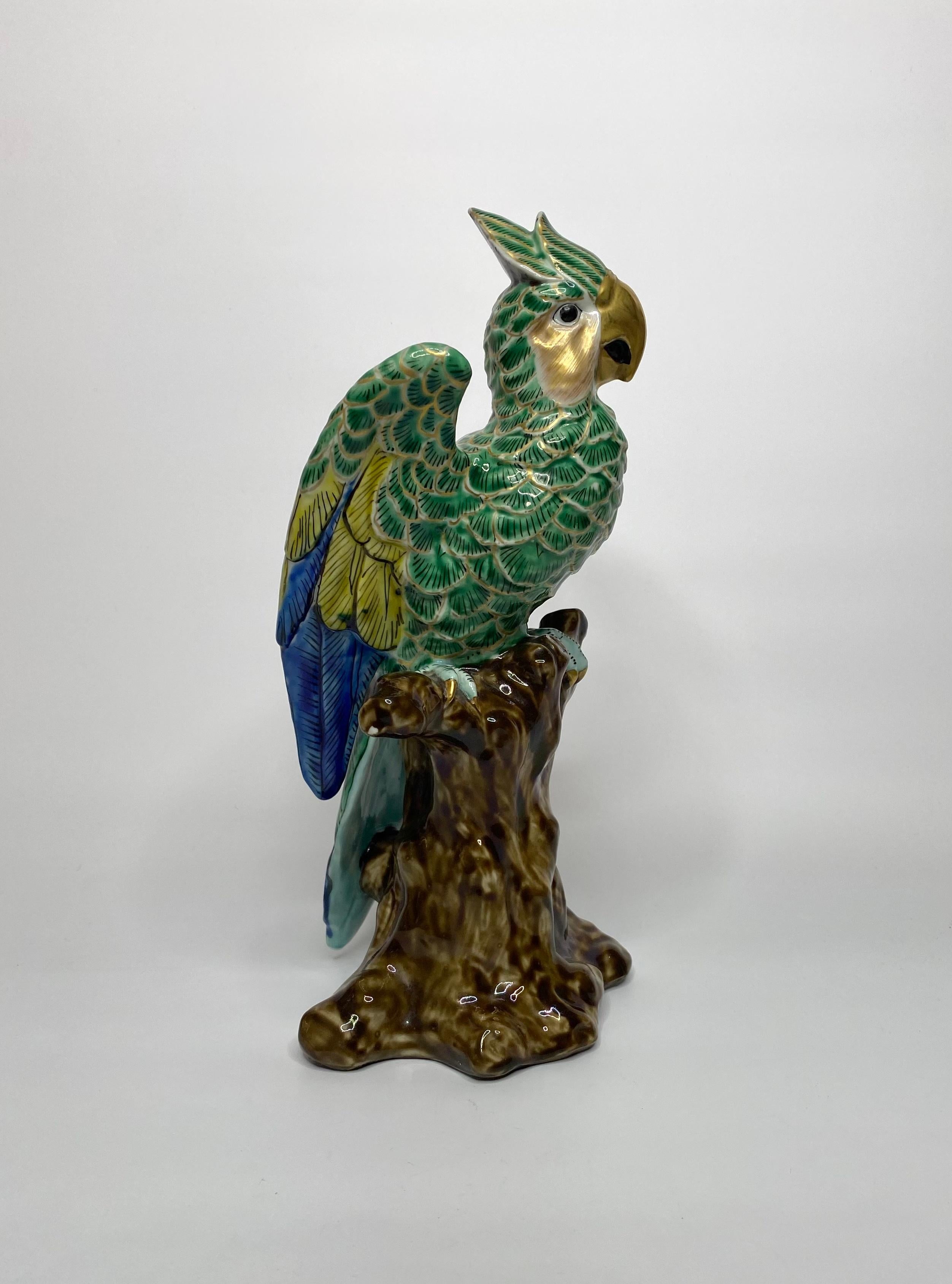 Kutani porcelain okimono of a parrot, Japan, circa 1890, Meiji Period. The brightly enamelled parrot, with his wings open, and having an alert expression on his face. Perched upon a large tree stump.
Measures: Height: 31.5 cm, 12 3/8”.
Width: 18