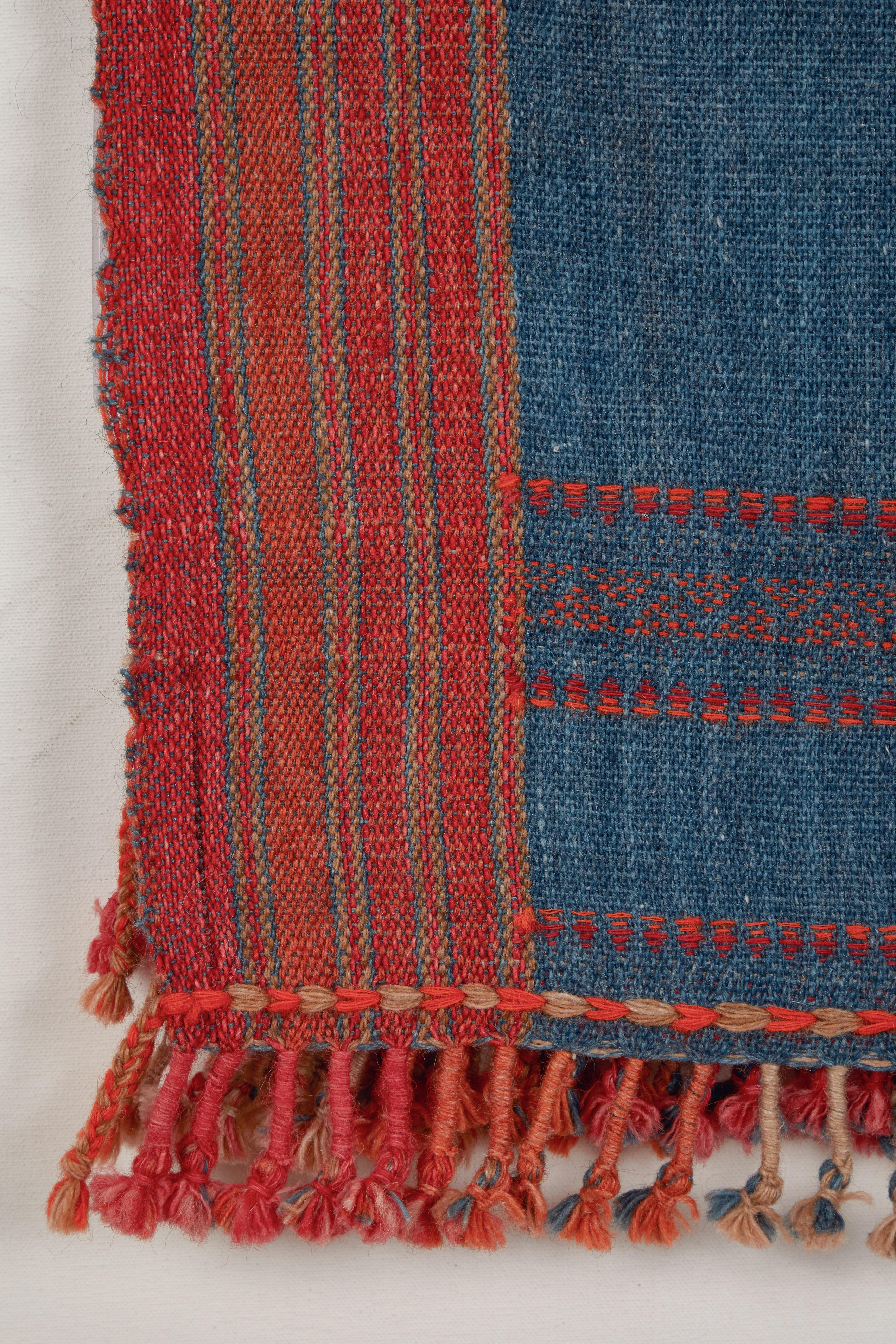 Handwoven wool throws with hand twisted tassels. Orange and indigo blue. Slightly fuzzy weave. Made in Kutch area of Gujarat, India.