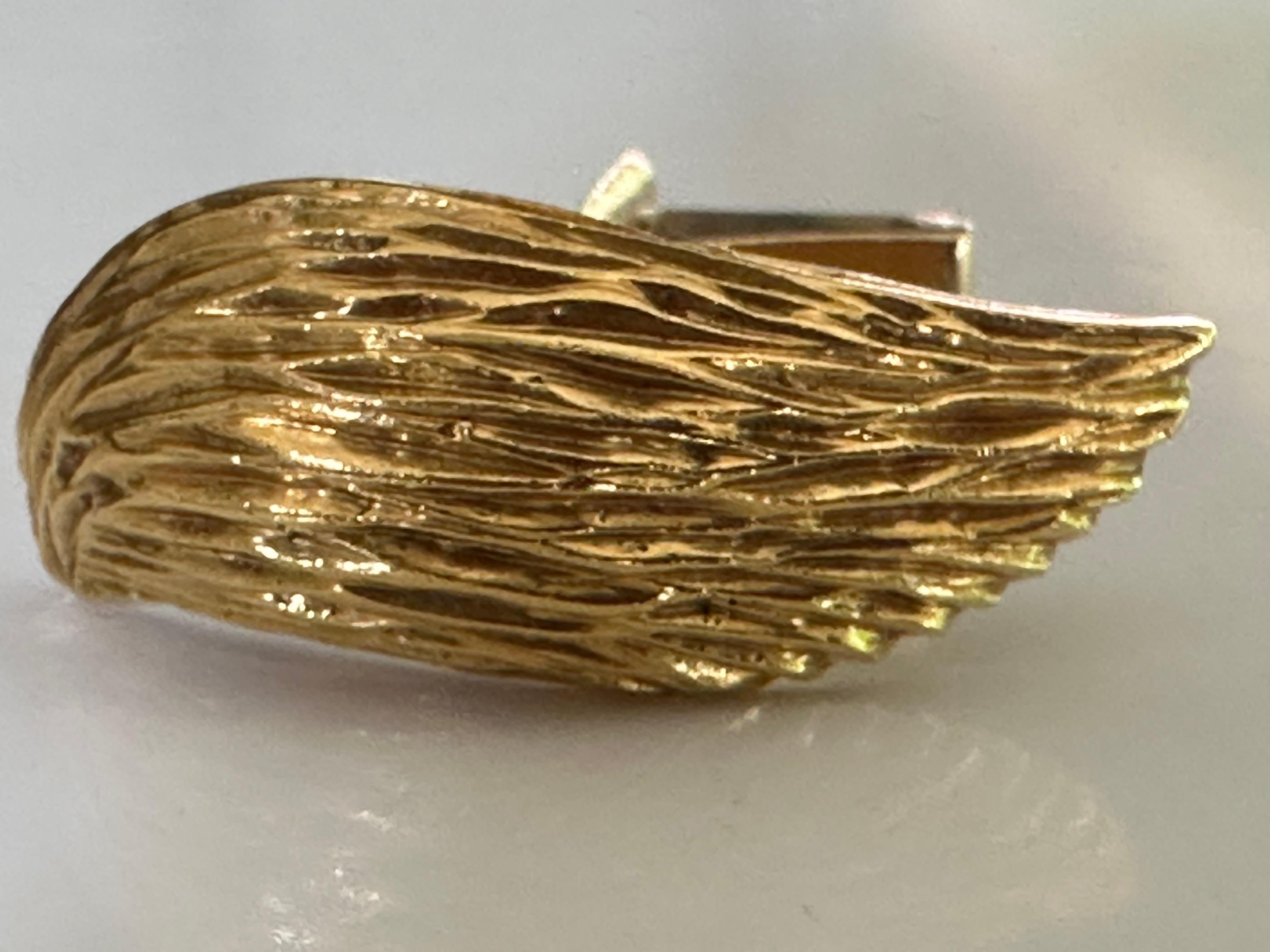 These Mid-Century winged cufflinks are artfully hand crafted in rich, highly textured 18K yellow gold by legendary London jeweler and goldsmith, Joseph Kutchinsky.  Stamped Kutchinsky. Circa 1970. 
 