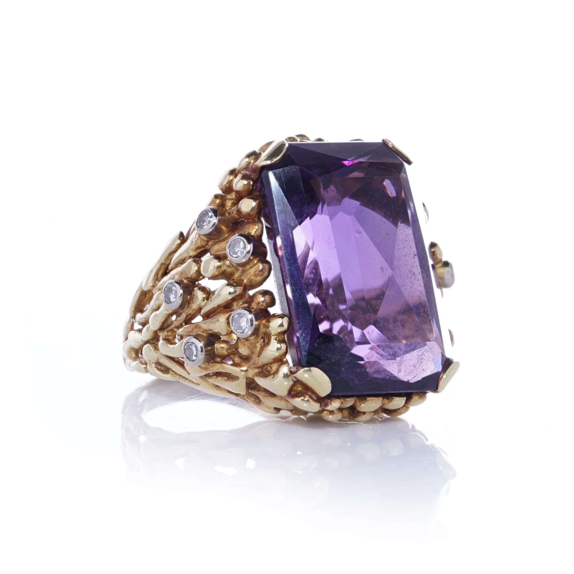Kutchinsky 18kt Gold Ladies Ring with Amethyst

This stunning ring, crafted by the iconic jewellery house Kutchinsky in the 1970s, features a richly textured 18kt yellow gold design. At its centre is a breathtaking emerald-cut natural amethyst,