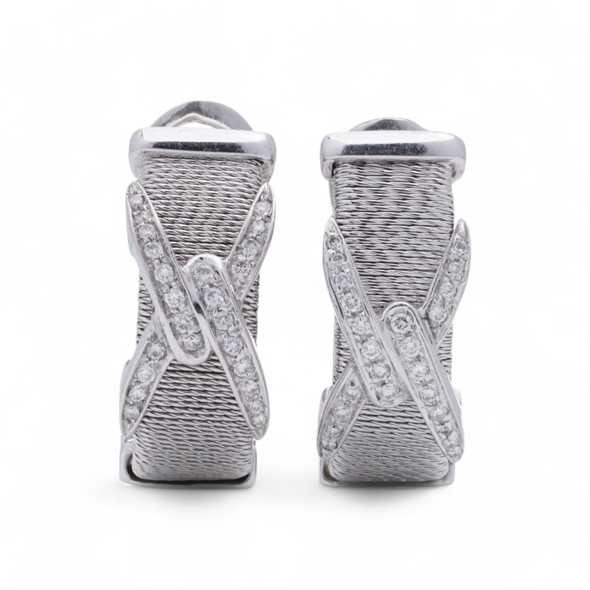 Kutchinsky 18kt White Gold Diamond Clip-On Earrings

A pair of 18kt white gold earrings by Kutchinsky, crafted in London during the 1960s–1970s. These earrings feature a textured gold surface adorned with pavé-set round brilliant-cut diamonds,