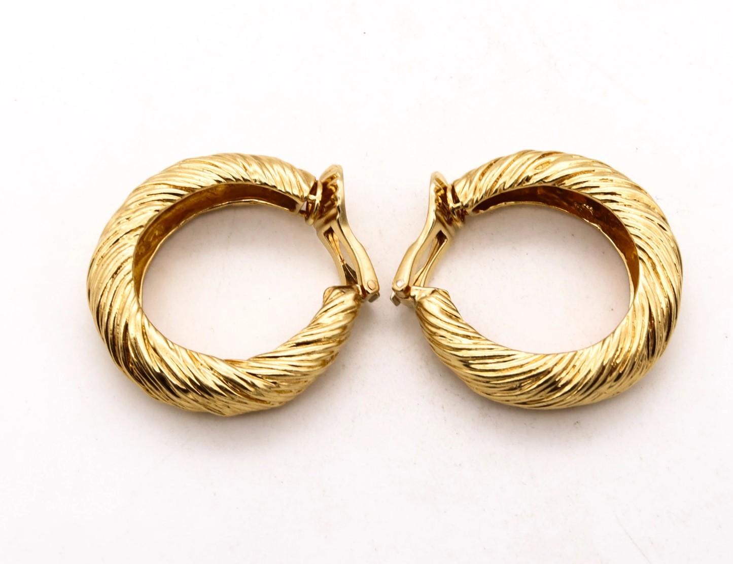 Pair of hoops earrings designed by Kutchinsky.

Great pair of hoop-earrings designed in London by the house of Kutchinsky, in 1972. They was crafted with great craftmanship in solid yellow gold of 18 karats and finished with lineal flakes textures.