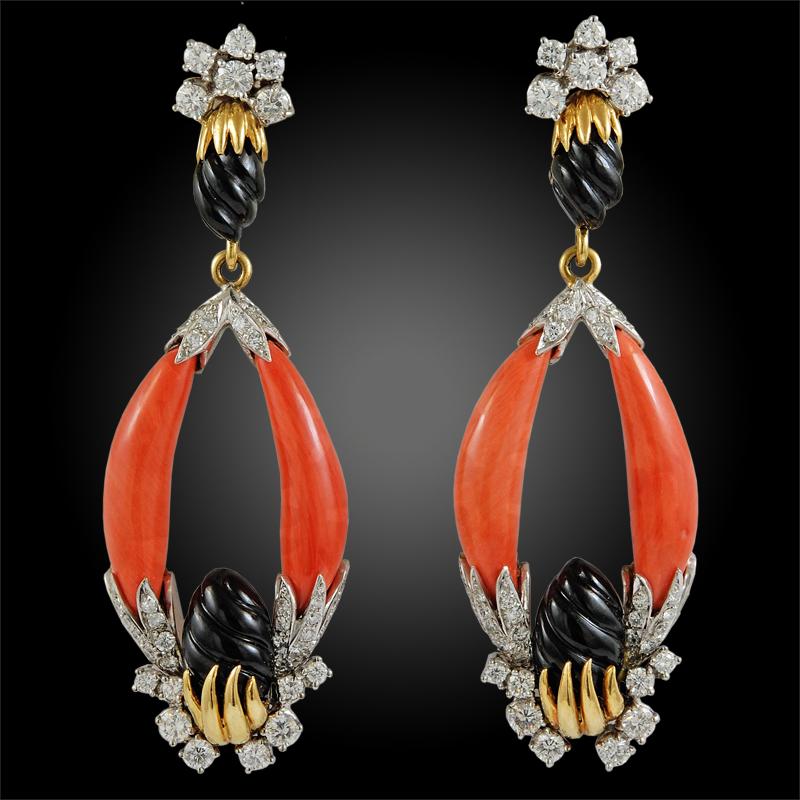 Exceptionally crafted by Kutchinsky in the 1970s, comprising a necklace, ring and earrings, each set with 18k yellow gold, coral, fluted onyx and brilliant cut diamonds in a geometric design. The suite is comprised with approximately 25 carats of