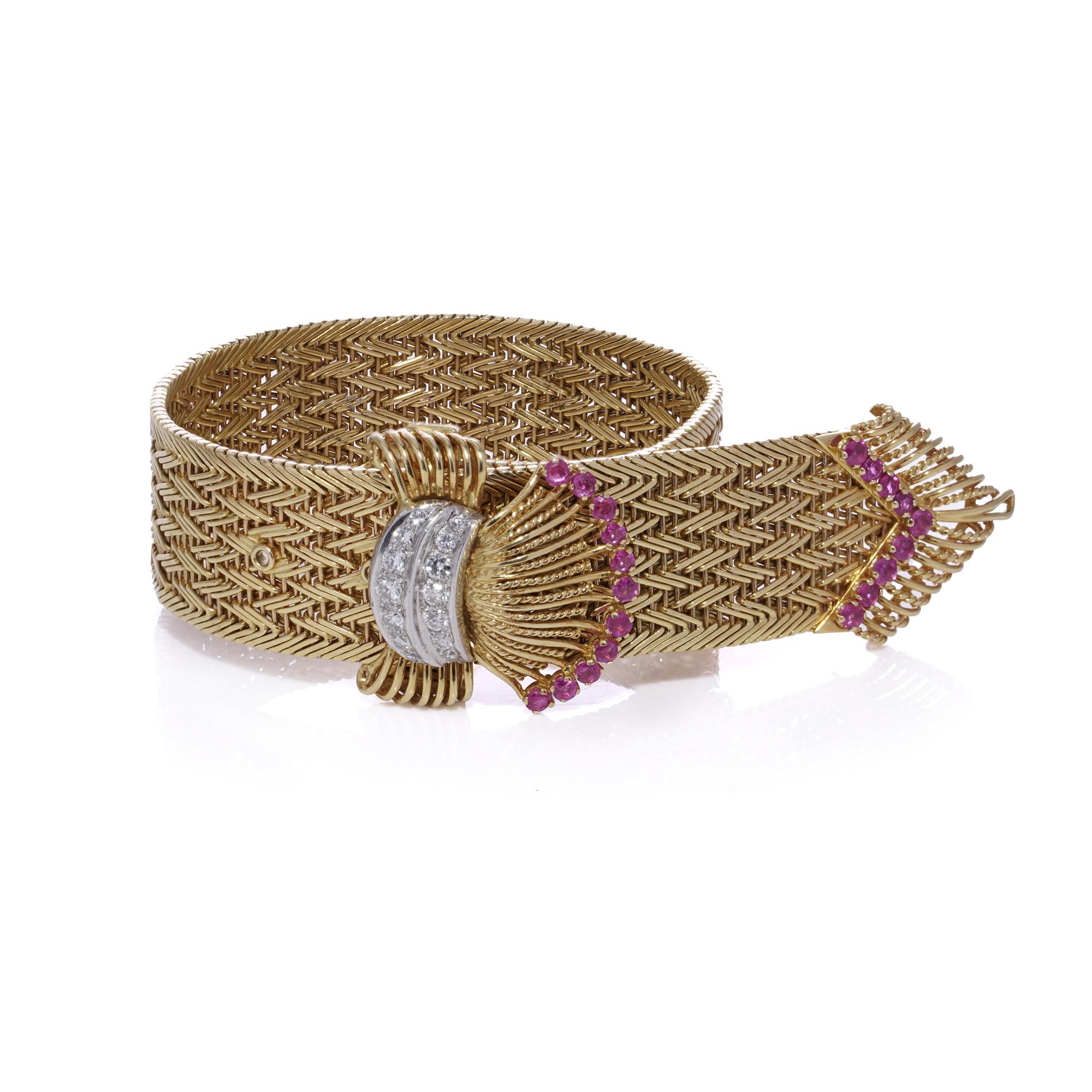 
Questo squisito orologio da cocktail in oro 18kt con diamanti e rubini, creato da Jaeger-LeCoultre per Kutchinsky, è caratterizzato da uno splendido bracciale jarretière intrecciato. Al centro, un motivo a forma di fibbia mette in evidenza