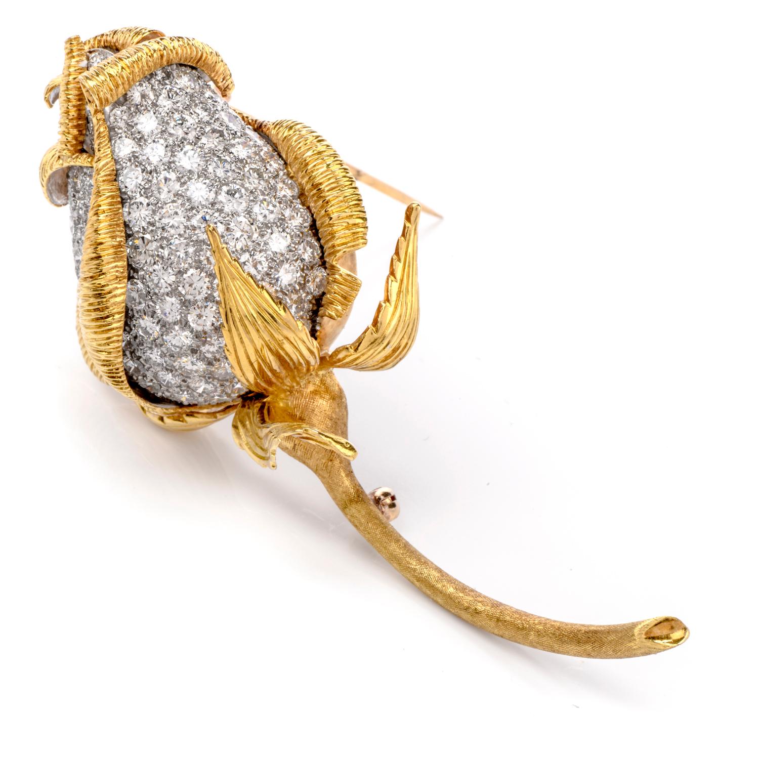 This sensational, Kutchinsky intricate brooch was handcrafted in 18K yellow gold and fashioned into a Rose Bud motif.

Yellow gold scalloped and carved leaves wrap the closed flower bud which consists of a contrasting color offered by the icy white